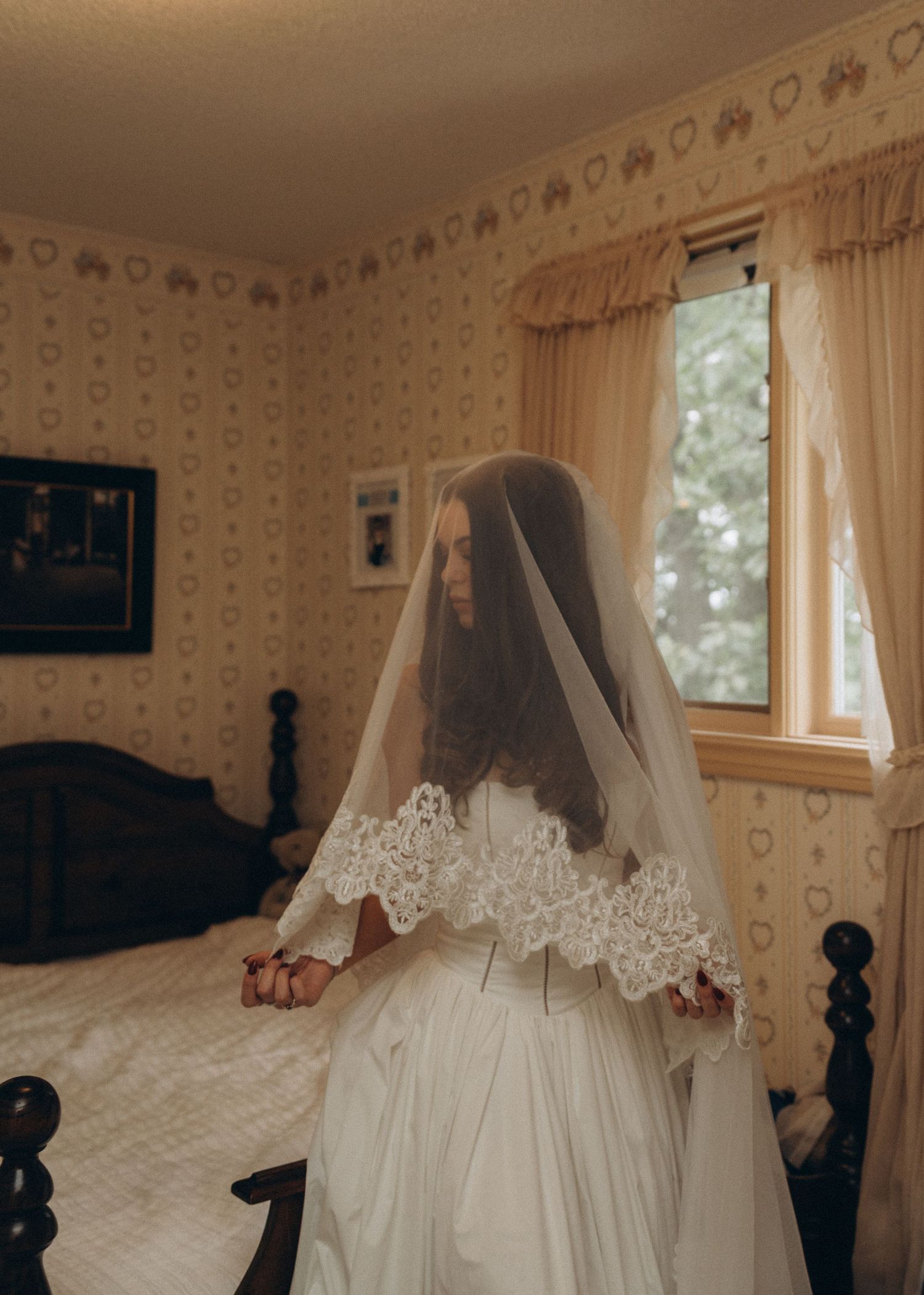 A series of vintage-style photos showing a white wedding dress with lace veil laid out on a floral wallpapered bed.