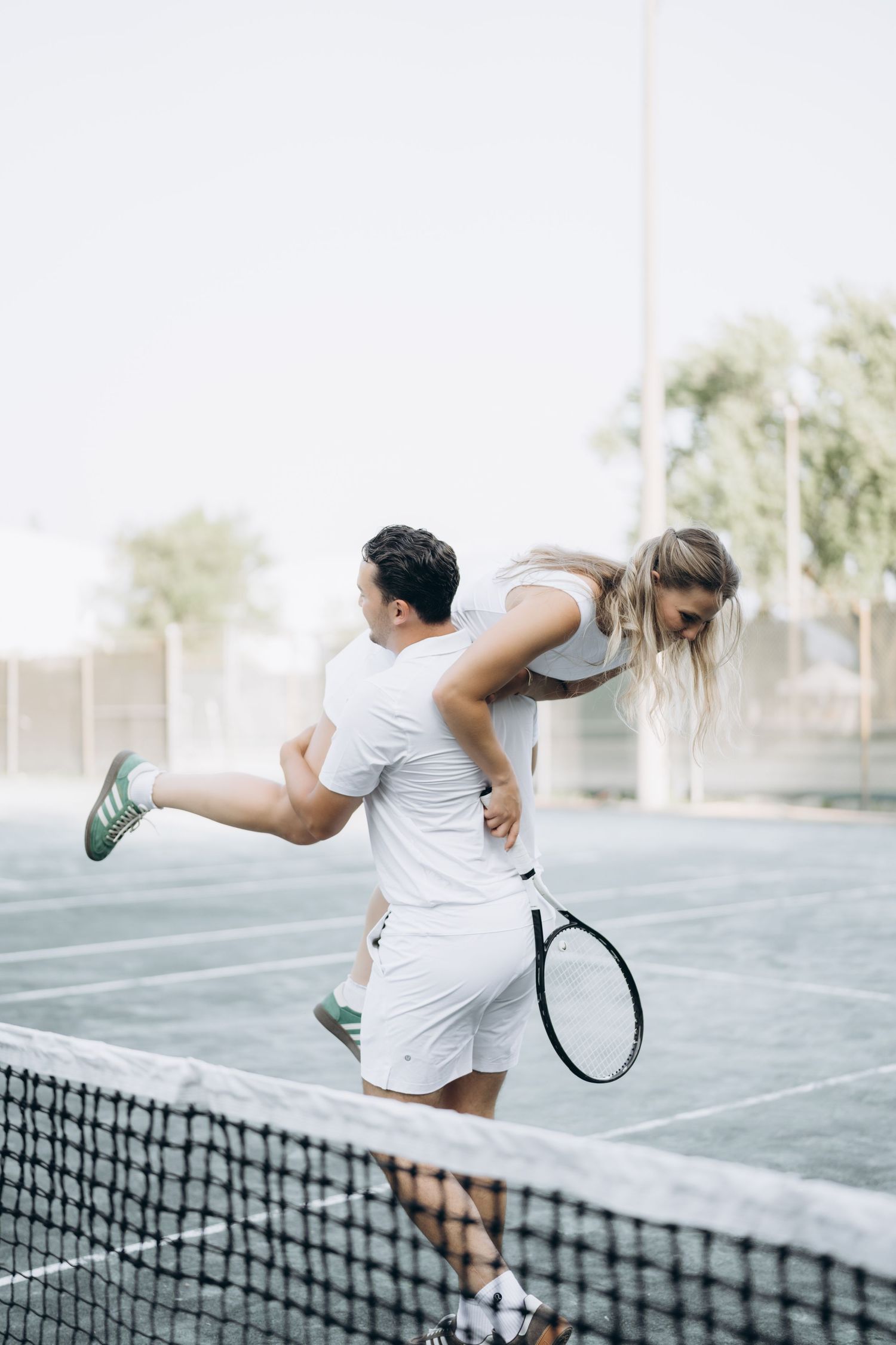 Three sequential photos show a figure jumping over a tennis net on an outdoor court.