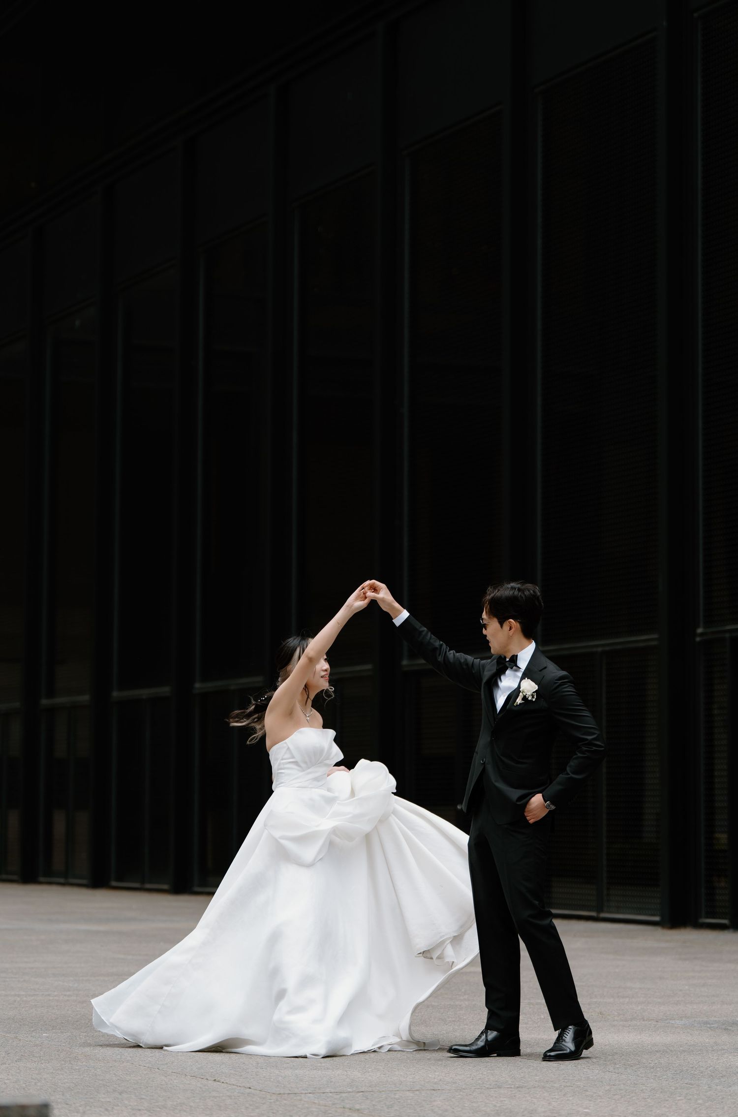 A series of romantic wedding photos showing the couple dancing and twirling in formal attire against a dark background.