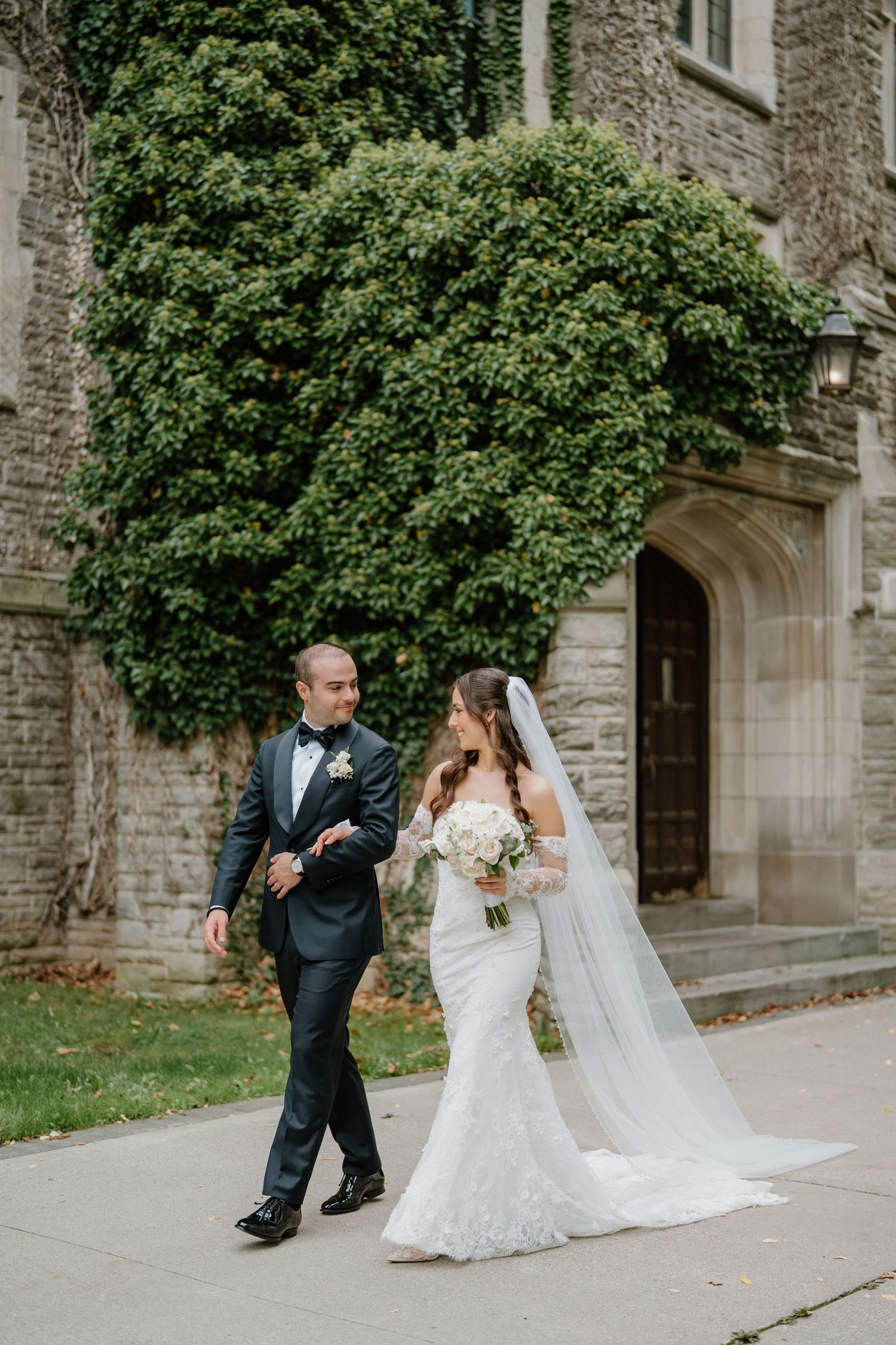 Sequence of wedding photos showing a couple walking together on a stone path beside a historic building.