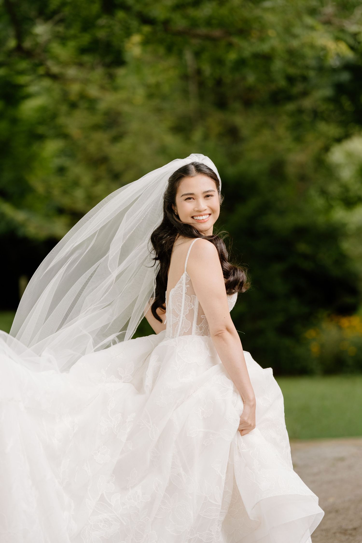 A bride in a flowing white wedding gown and veil poses playfully in a series of outdoor portraits against a green background.