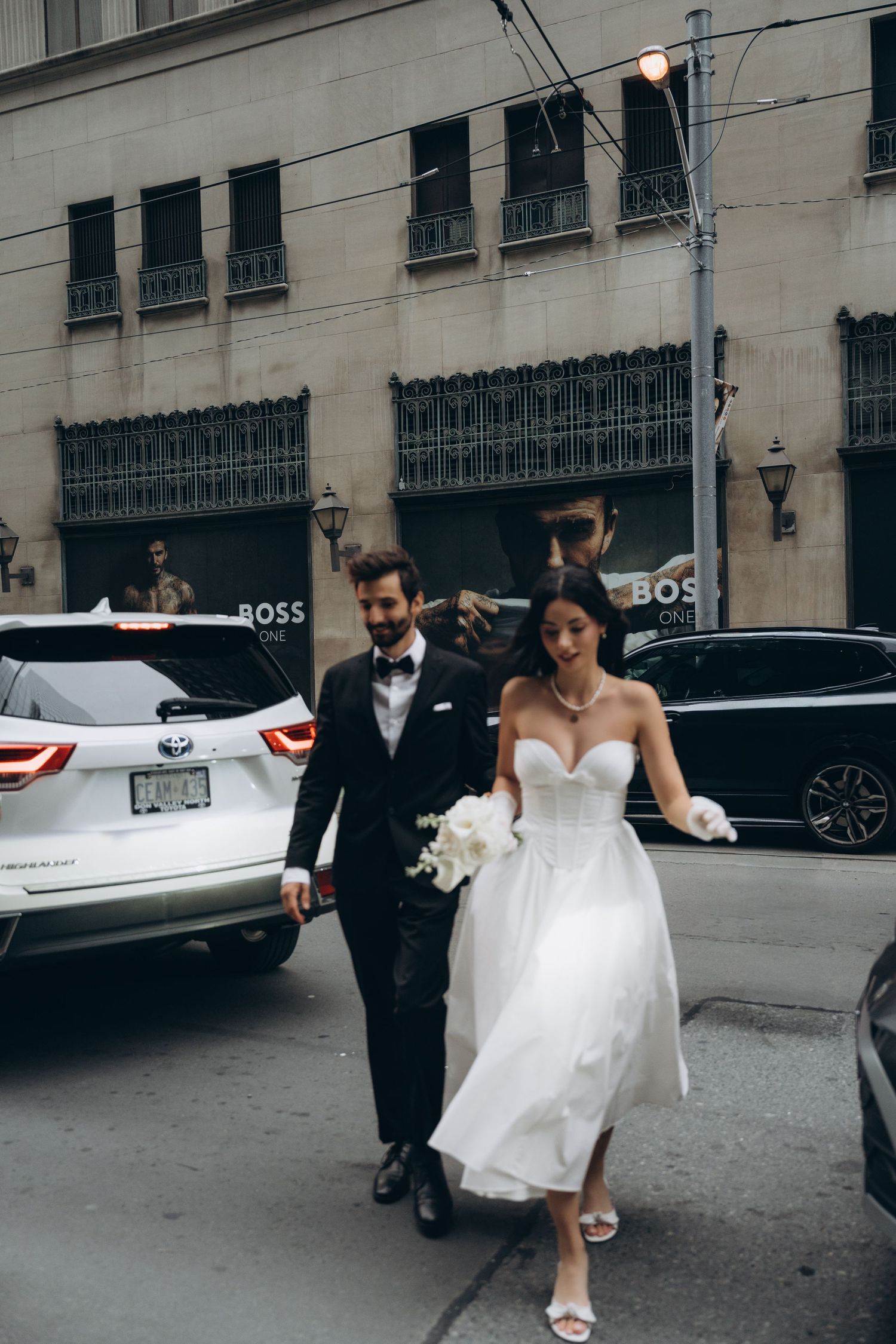 Romantic stroll of a bride and groom in a Toronto park captured by AZ Photo Studio.