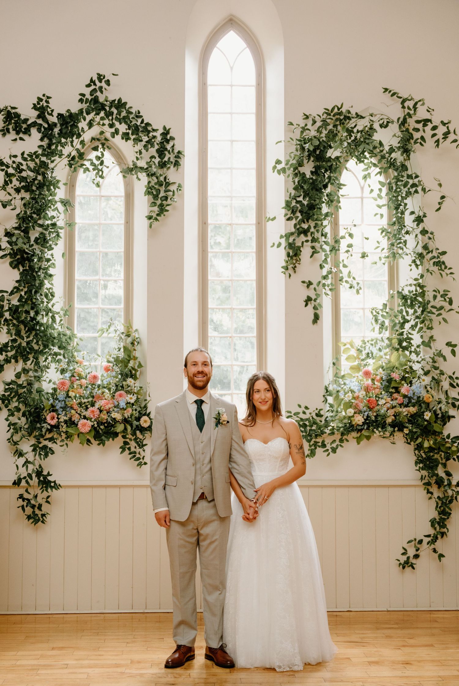 A romantic wedding photo collage showing couple posing in front of white windows adorned with climbing greenery and flowers.