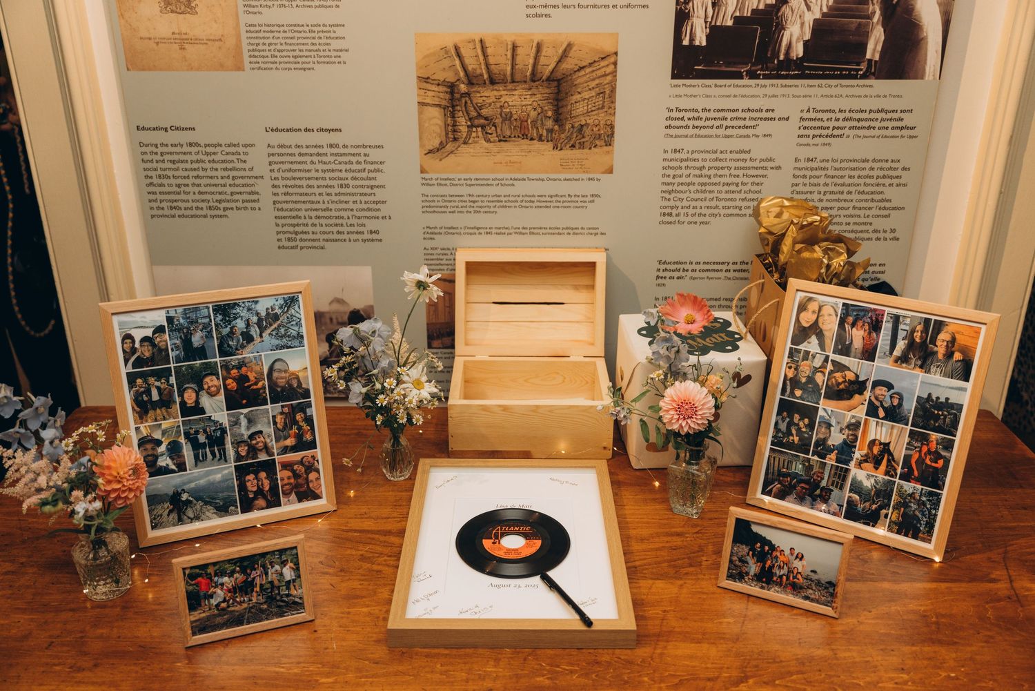 A series of framed photographs and memorabilia displayed on wooden surfaces with flowers and decorative items.