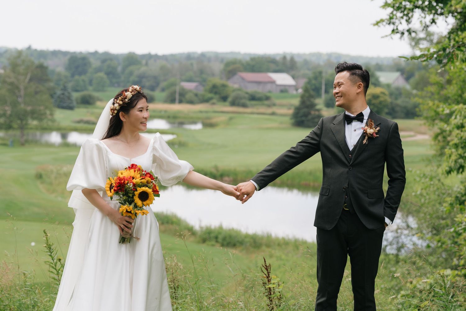 Bride and groom holding hands by the pond at Pheasant Run Golf Club, wedding photography by AZ Photo Studio cinematic shoot.