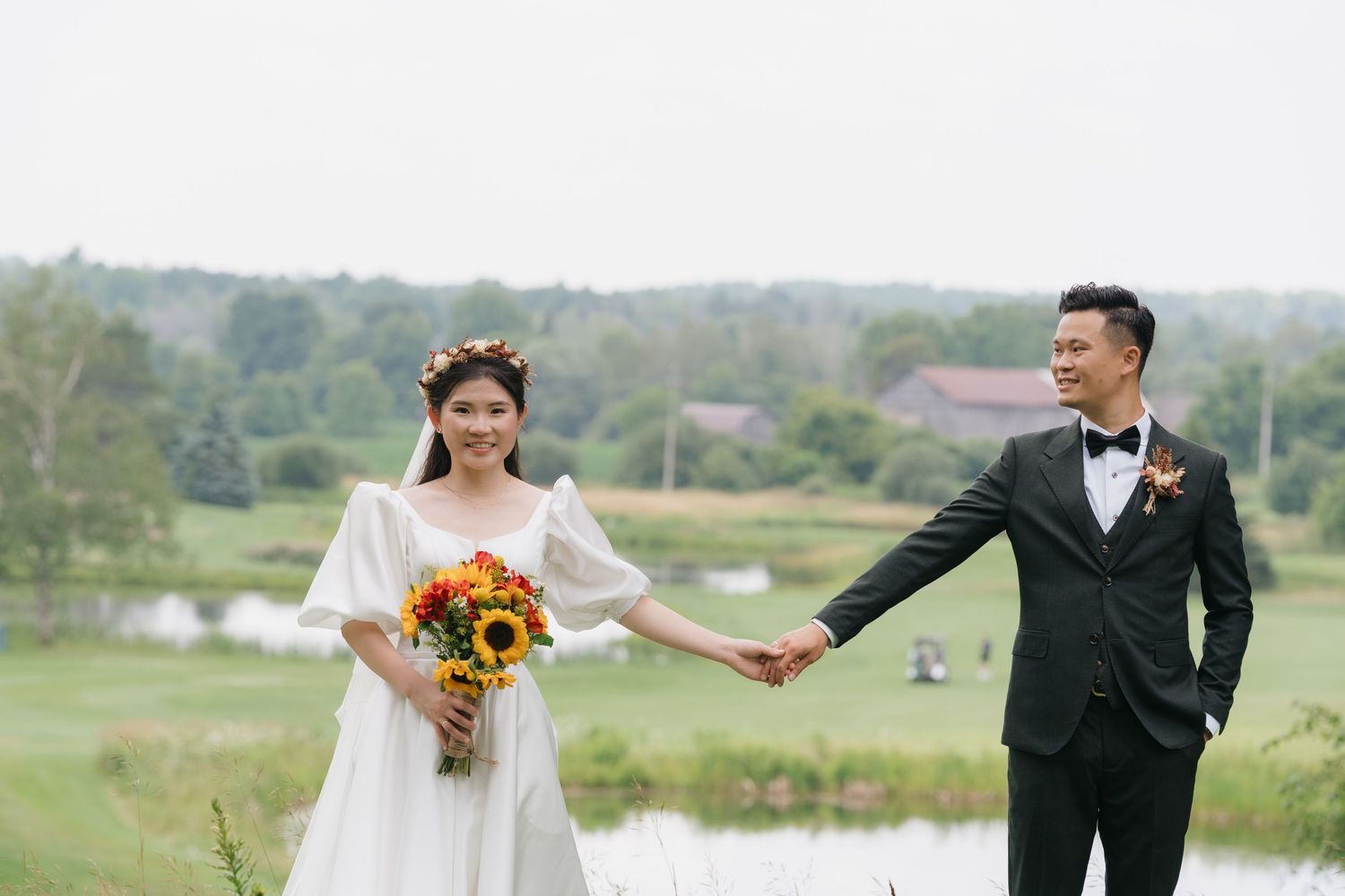 Bride and groom holding hands by the pond at Pheasant Run Golf Club, wedding photography by AZ Photo Studio.