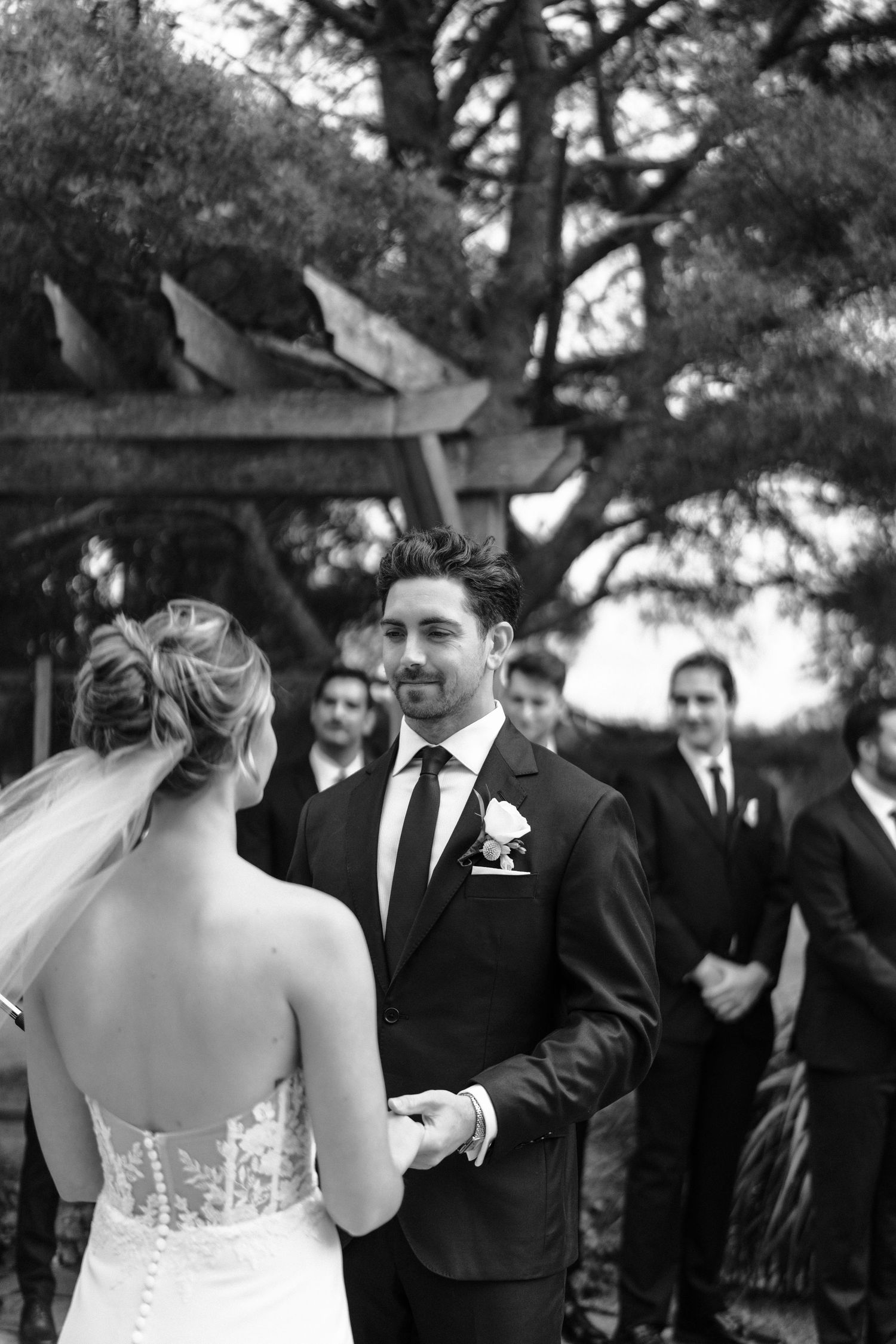 A black and white photo sequence shows a candid moment between a bride and groom during their outdoor wedding ceremony.
