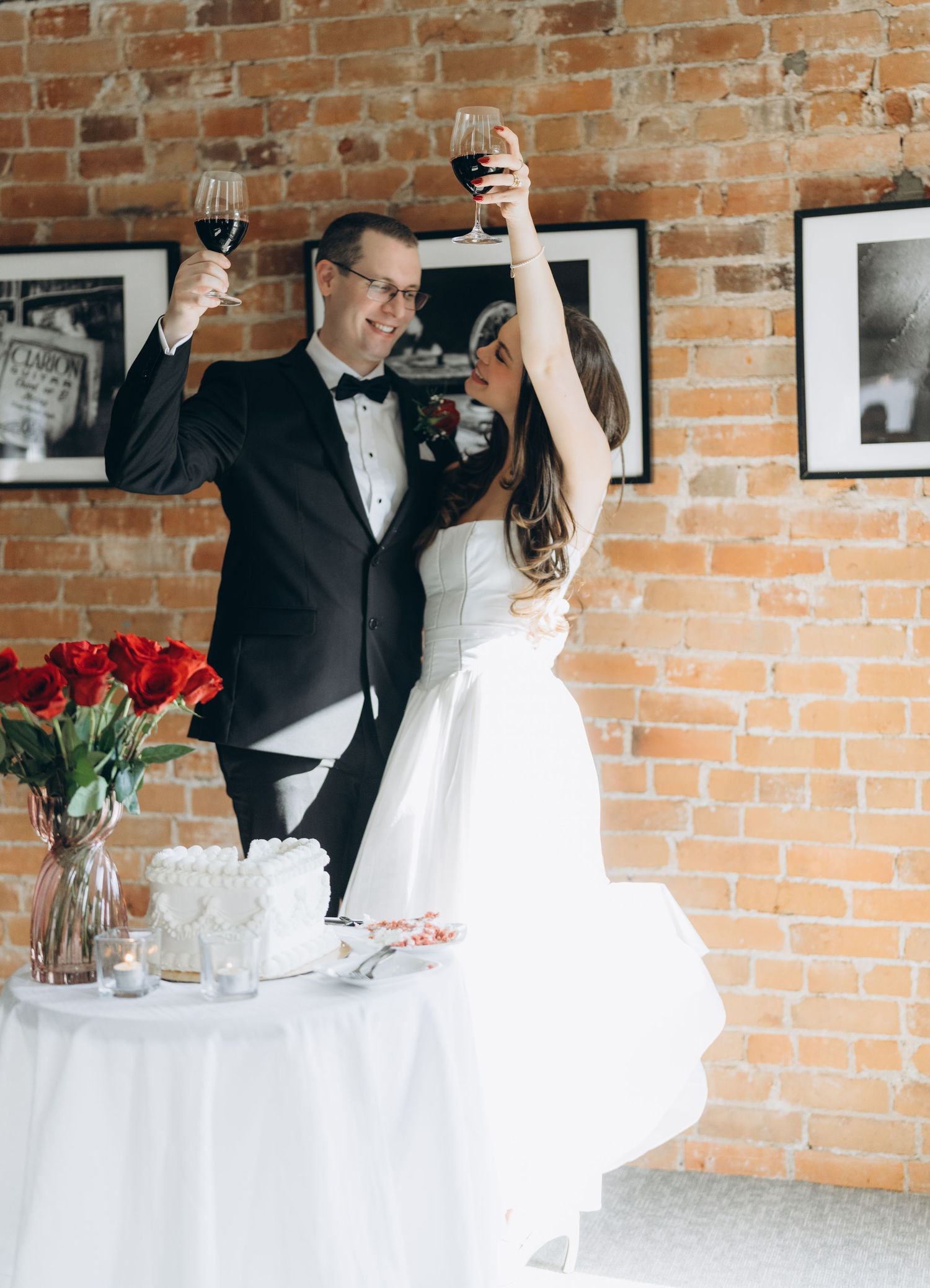A series of four wedding photos with wine glasses and red roses against an exposed brick wall backdrop.