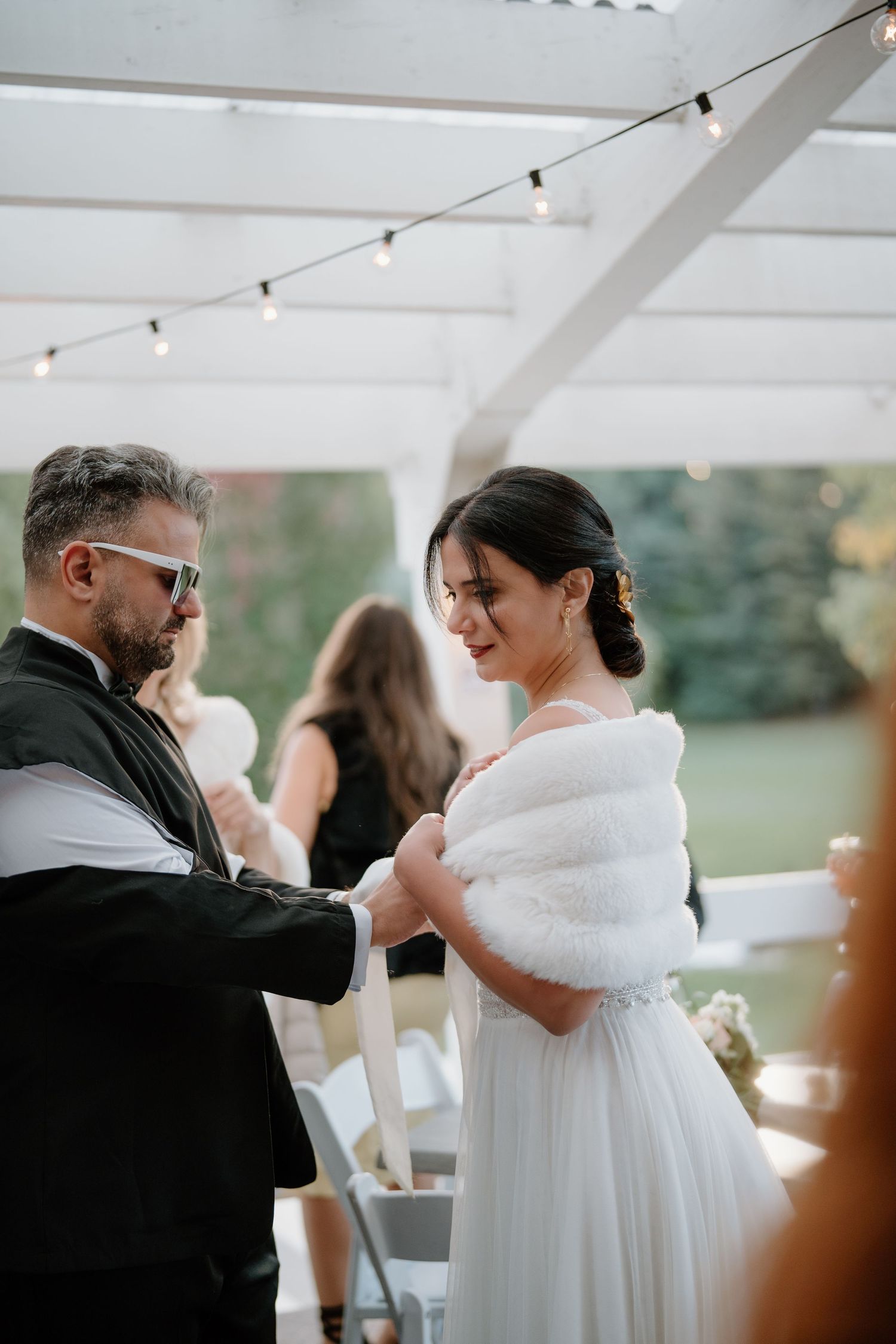 An intimate moment between a couple during their outdoor wedding reception.
