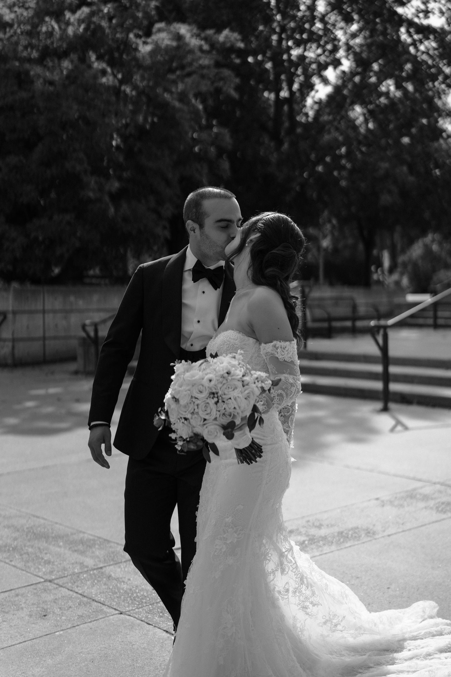 A romantic black and white wedding photo sequence showing tender moments between a couple in formal attire outdoors.