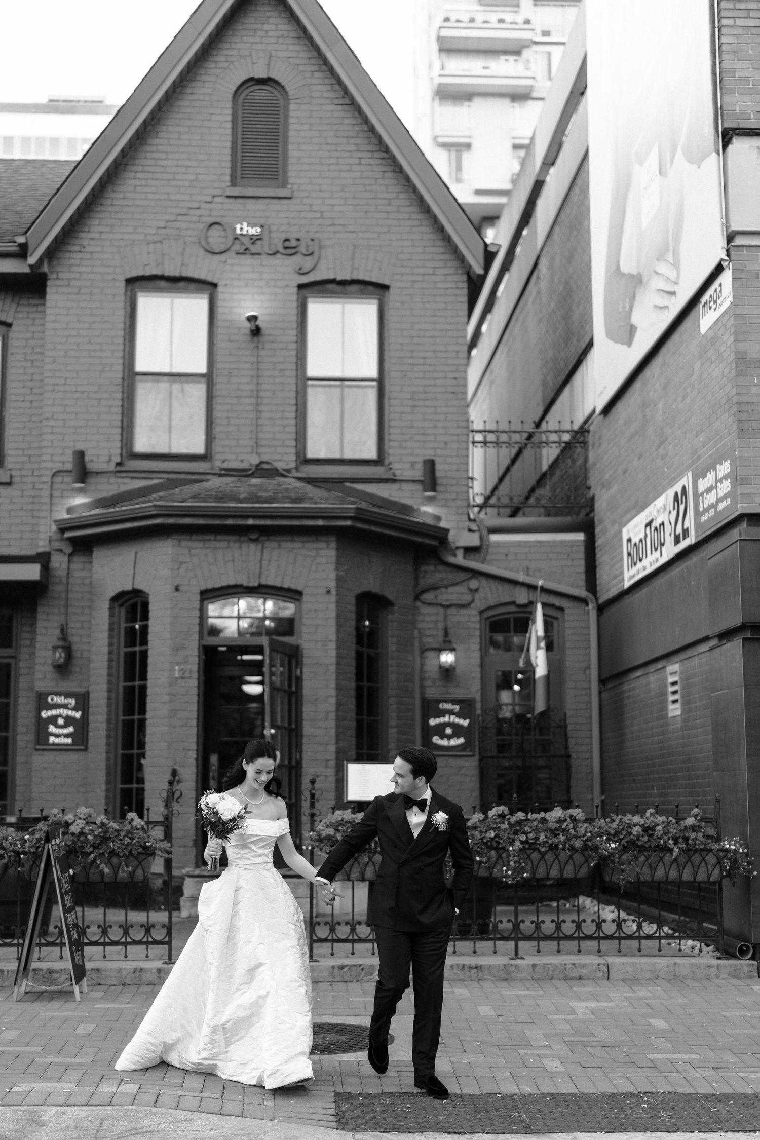 A sequence of black and white wedding photos showing a couple in formal attire outside a Victorian-style house.