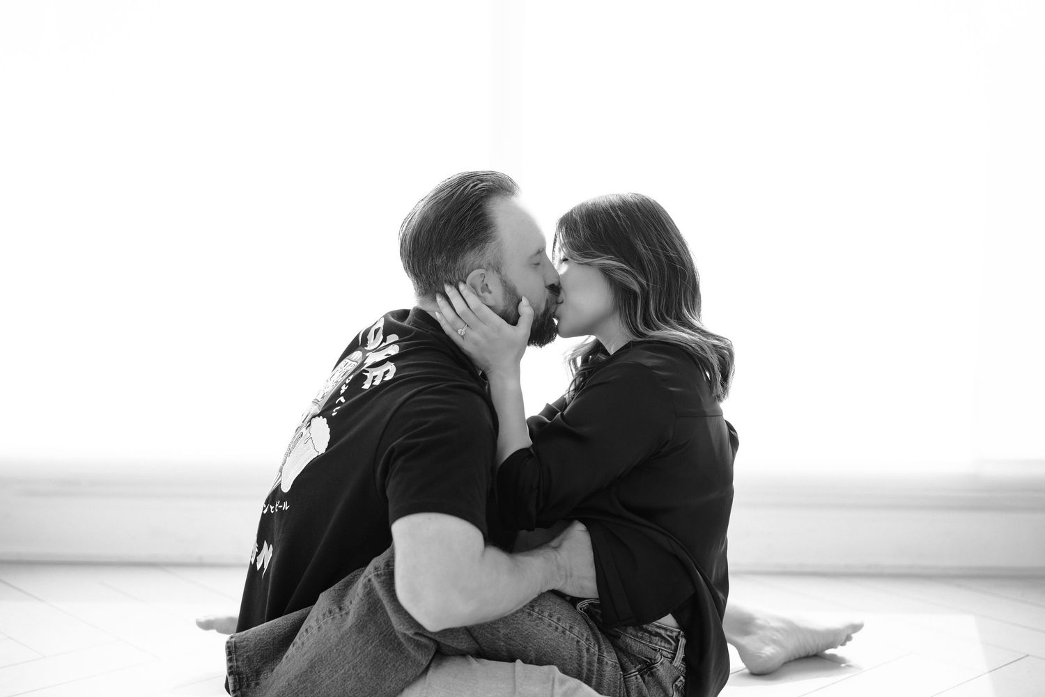 Black and white photo series showing a romantic couple embracing and dancing together in an intimate moment.