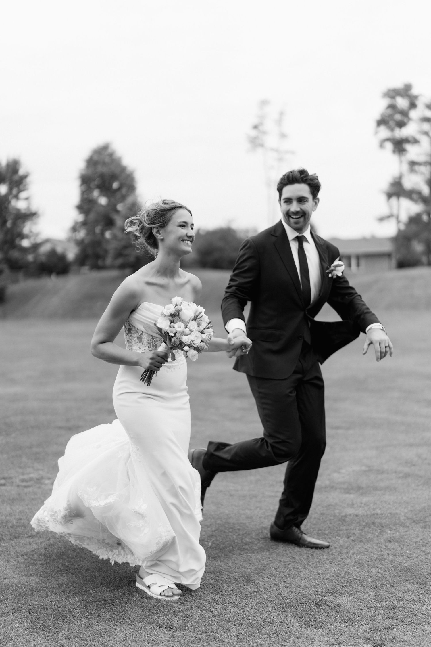 Black and white wedding photo sequence shows couple playfully running and posing together on grassy field.
