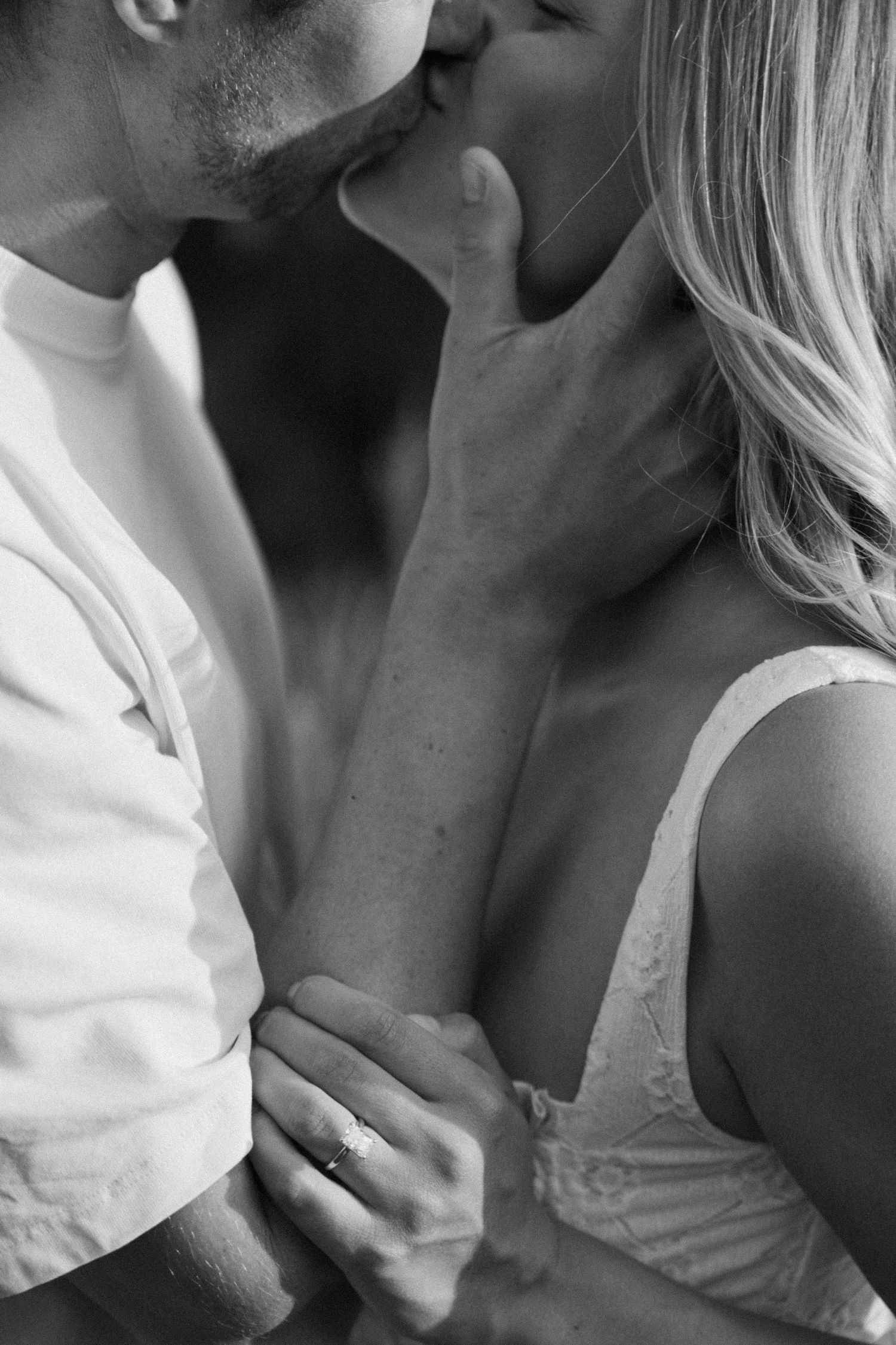 Intimate black and white close-up of a romantic couple sharing a tender moment together.