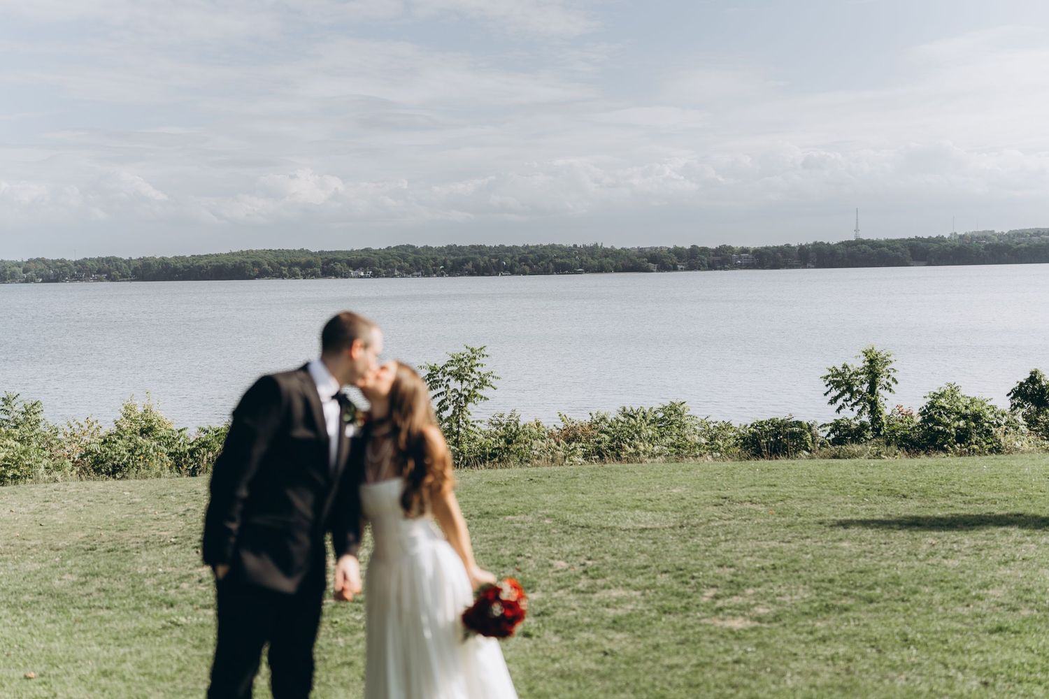 Newlyweds share romantic moments in serene outdoor settings with scenic coastal views and lush green landscapes.