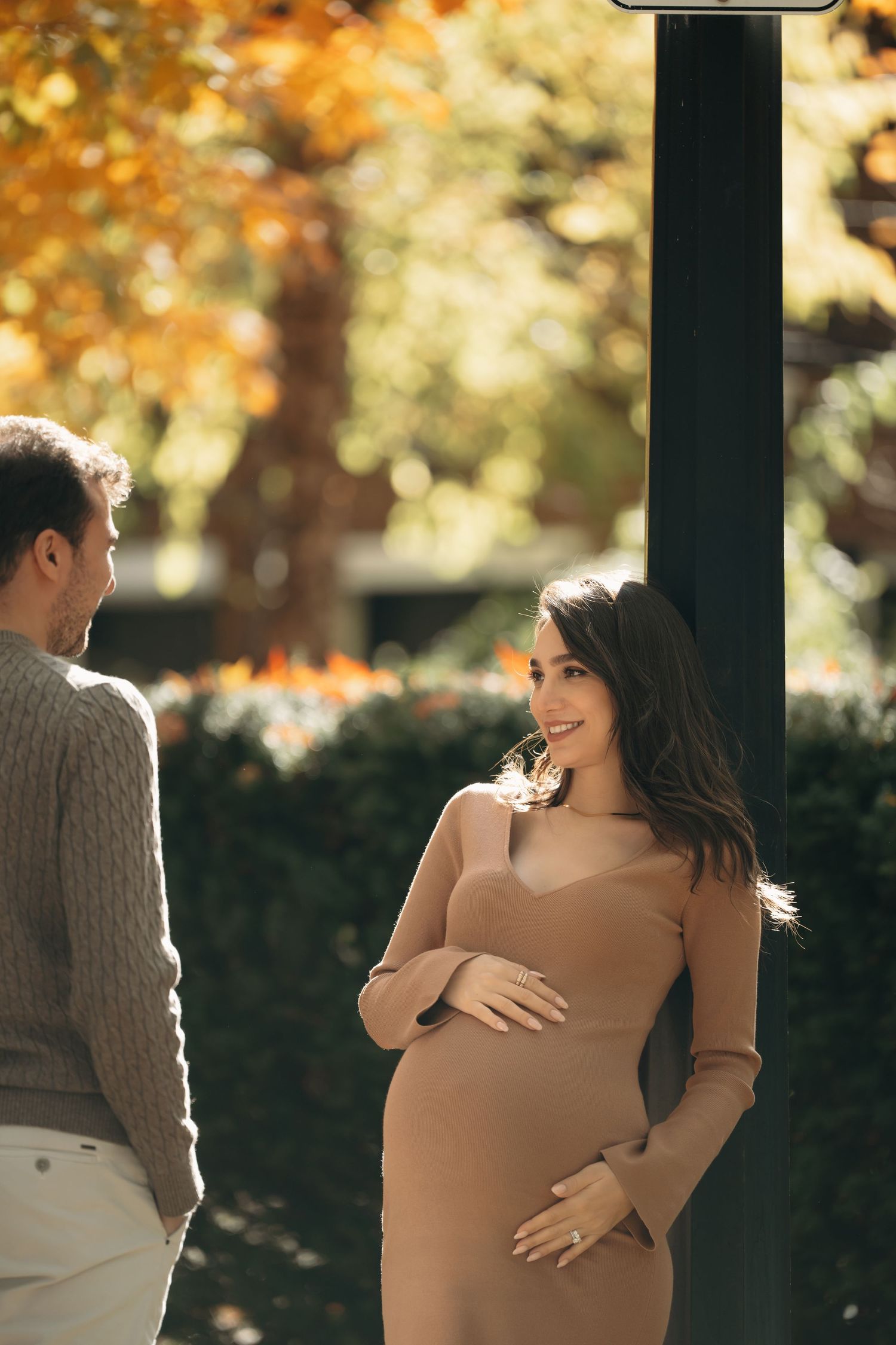 A collage of four tender maternity moments depicting a couple embracing outdoors during an autumn photoshoot session.