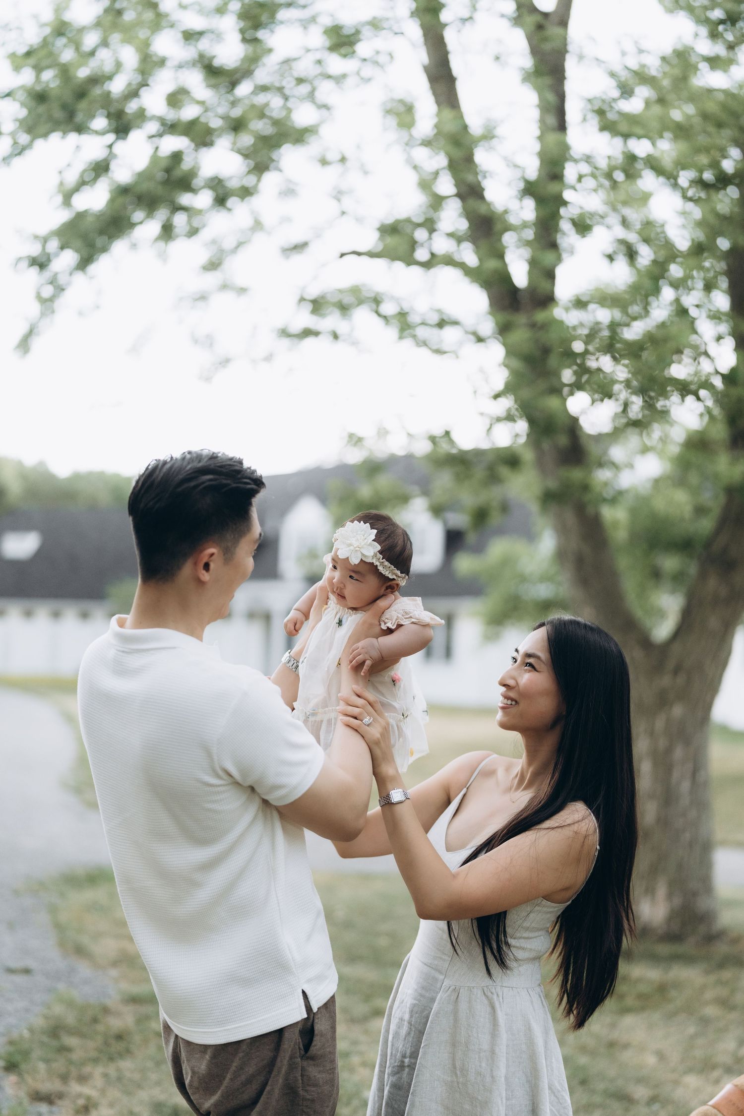 A joyful outdoor family moment captured in a series of natural, candid poses under green trees.