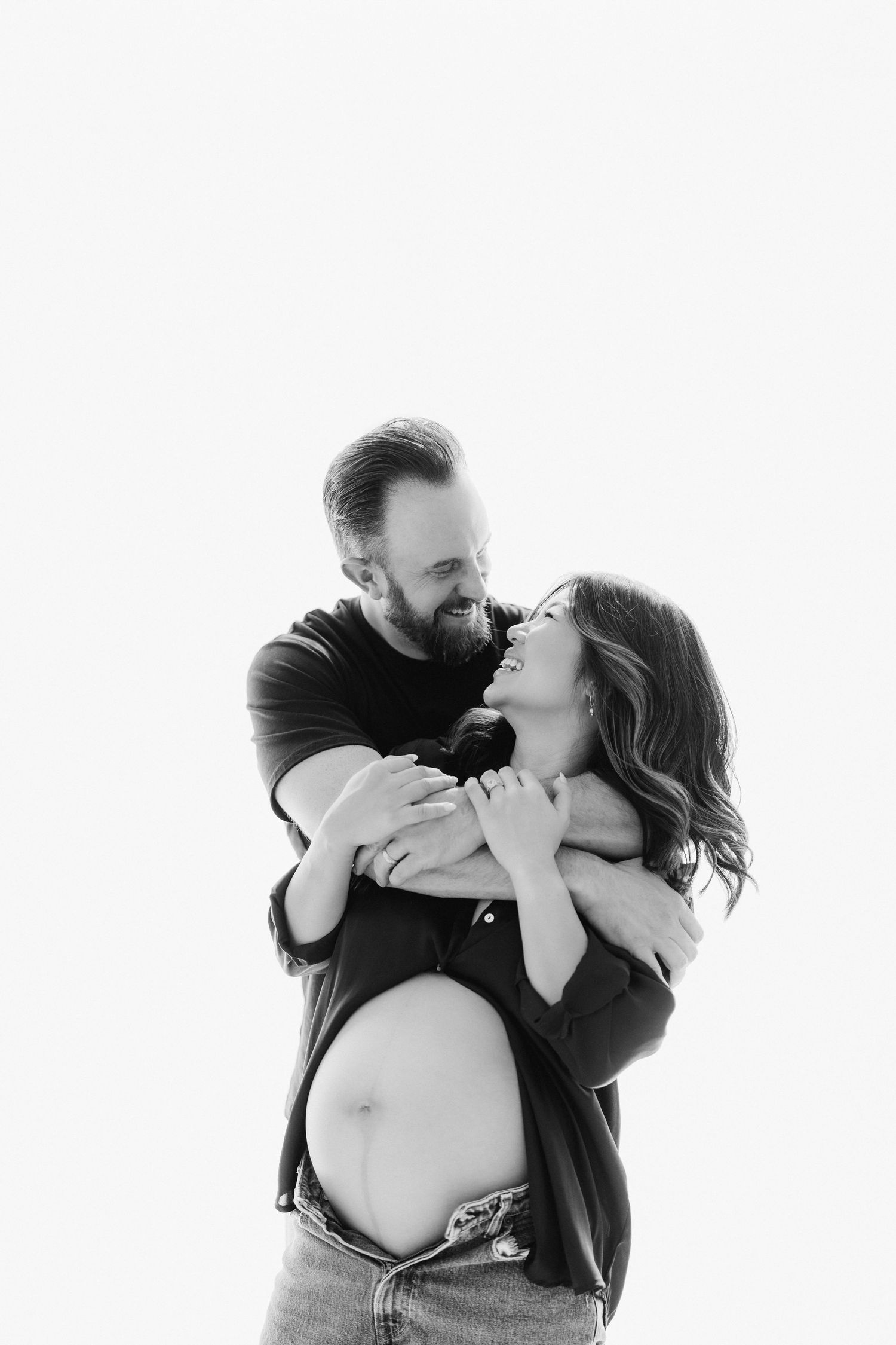 A couple shares an intimate kiss in black and white photography, shown in three progressive shots.