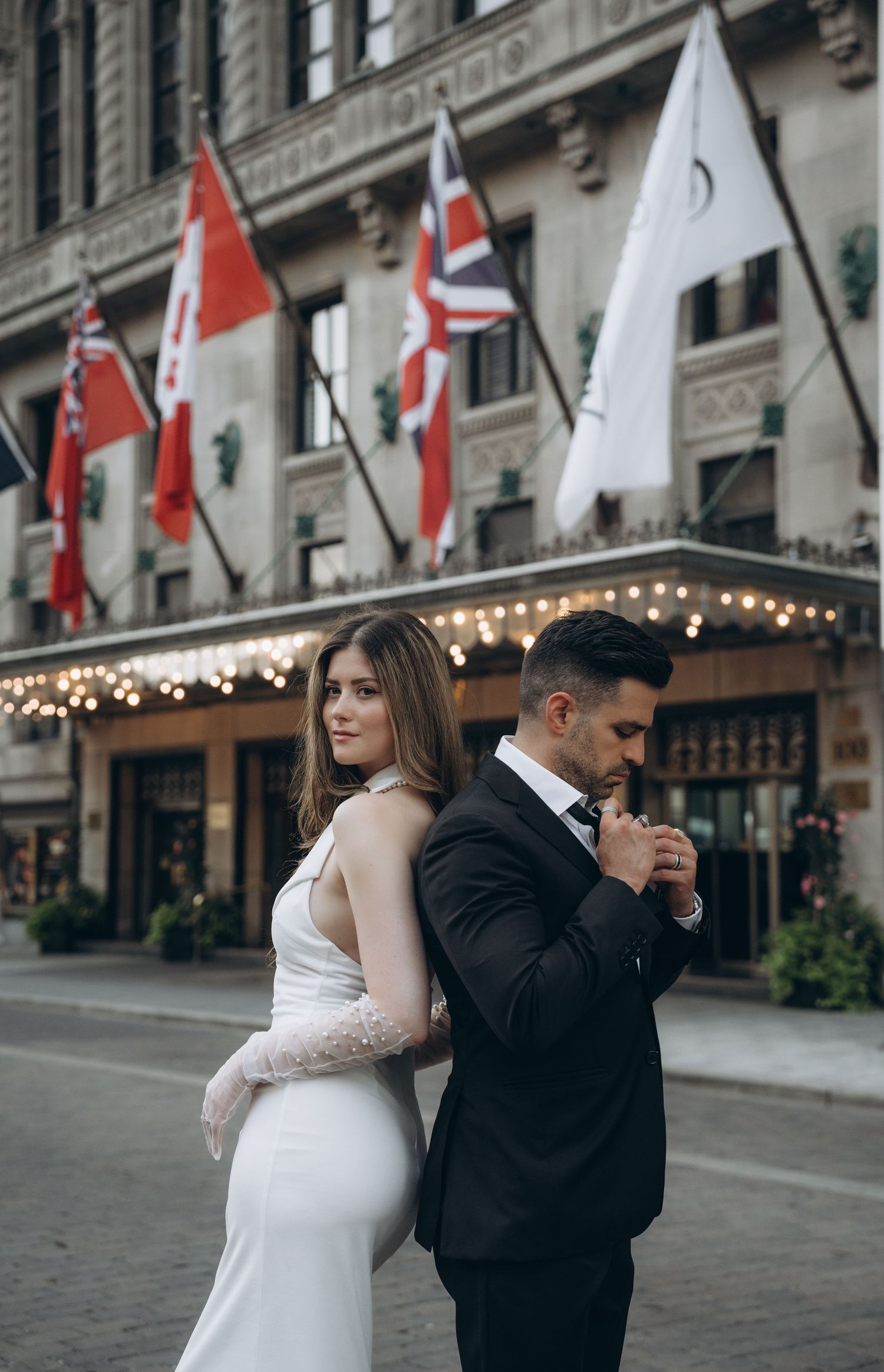 A sequence of romantic wedding photos showing a couple dancing together on a cobblestone street with flags in the background.
