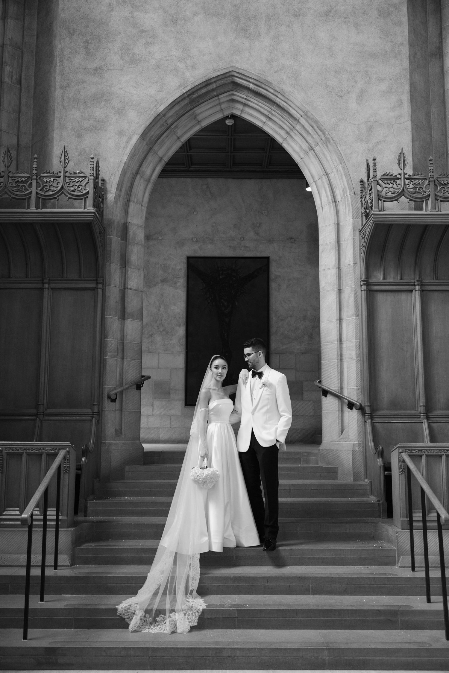 A black and white panoramic wedding photo sequence showing a couple in formal attire on church steps.