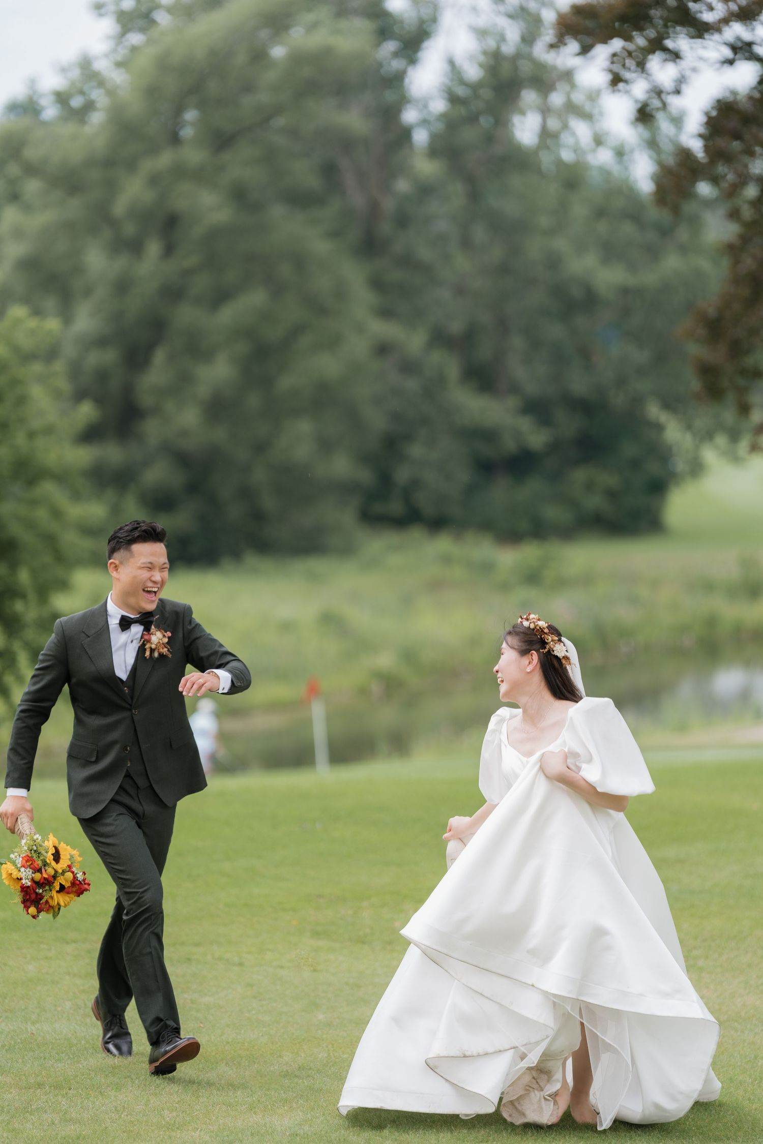 Playful bride and groom chasing each other on the green at Pheasant Run Golf Club, AZ Photo Studio.
