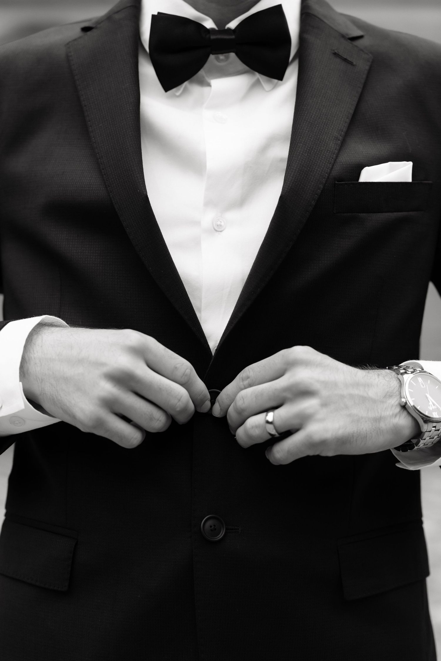 Close-up black and white photos of formal attire showing hands adjusting bow ties and tuxedo details.