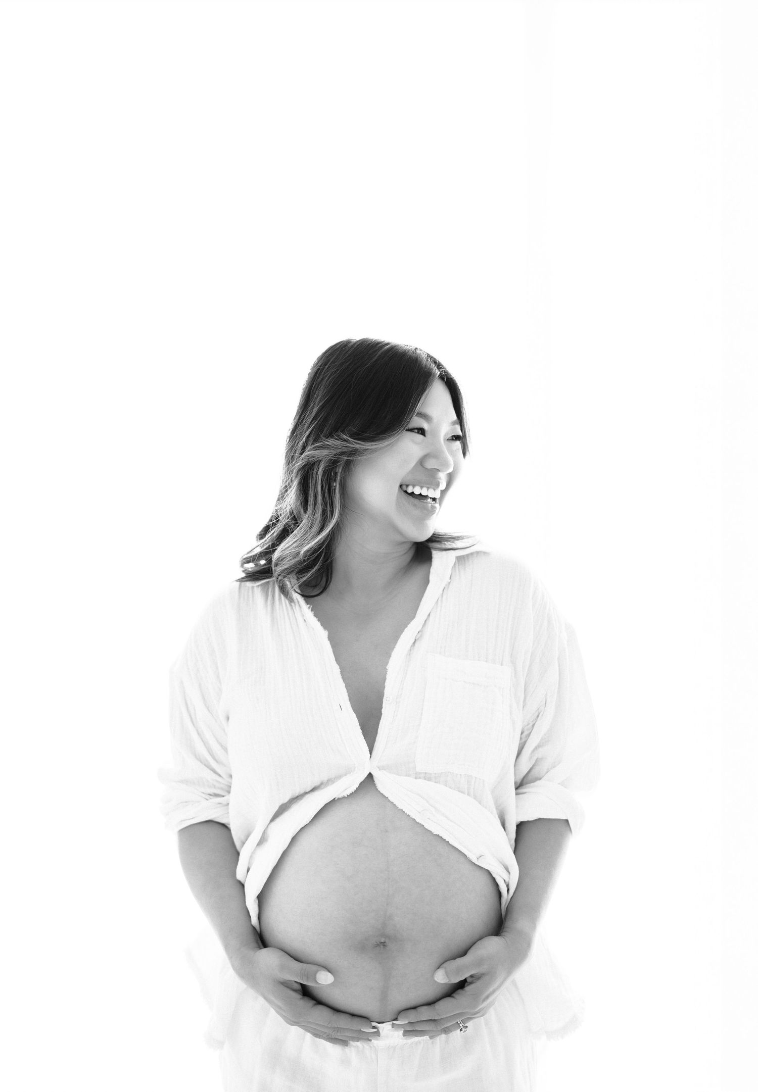 A black and white artistic portrait series showing a woman in white clothing against a light background.