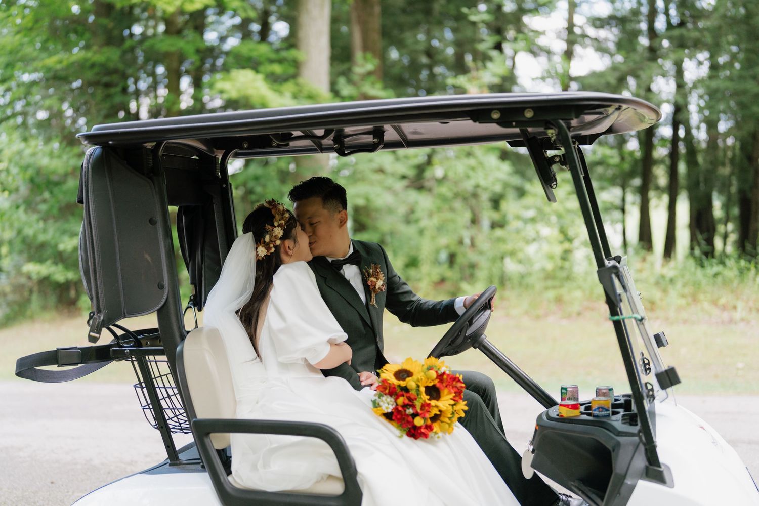 Newlyweds sharing a kiss in their wedding golf cart, Pheasant Run Golf Club photography by AZ Photo Studio.