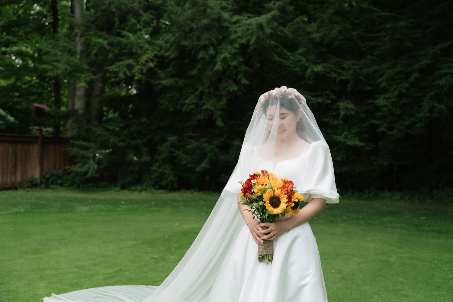Detailed shot of a bride’s gown in a natural garden setting captured by AZ Photo Studio