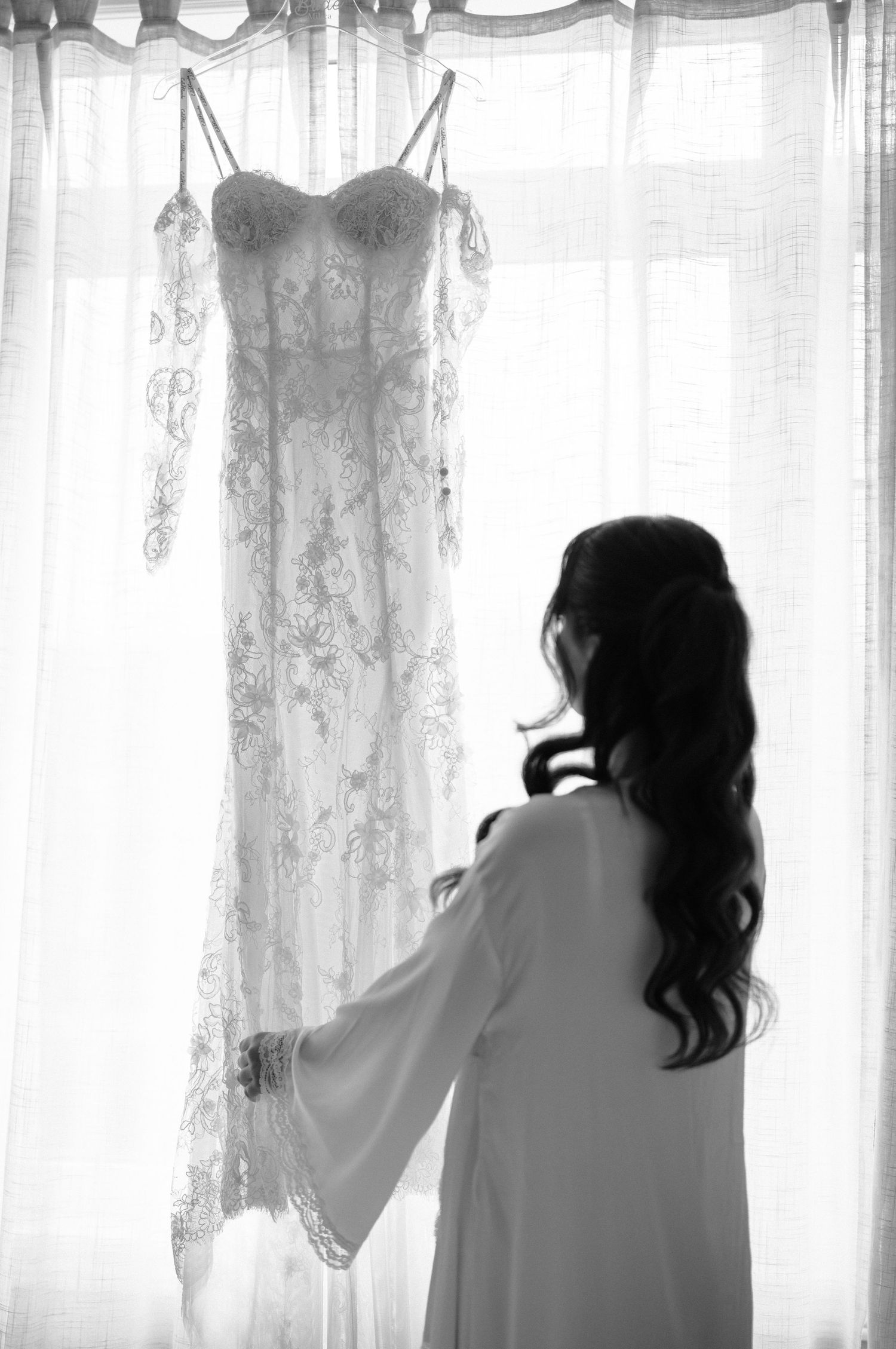 A sequence of silhouettes showing a person looking through curtains in different poses.