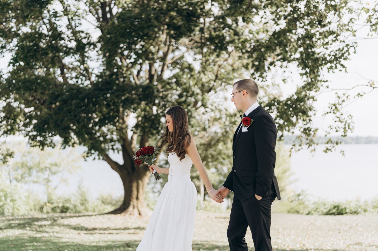 Wedding couple portraits in a scenic outdoor setting with natural greenery and soft lighting.