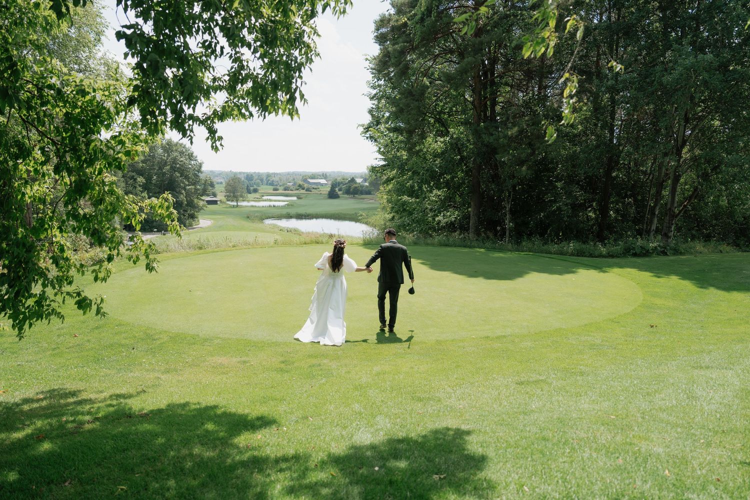 Bride and groom standing in the middle of the lush golf course at Pheasant Run Golf Club, AZ Photo Studio.