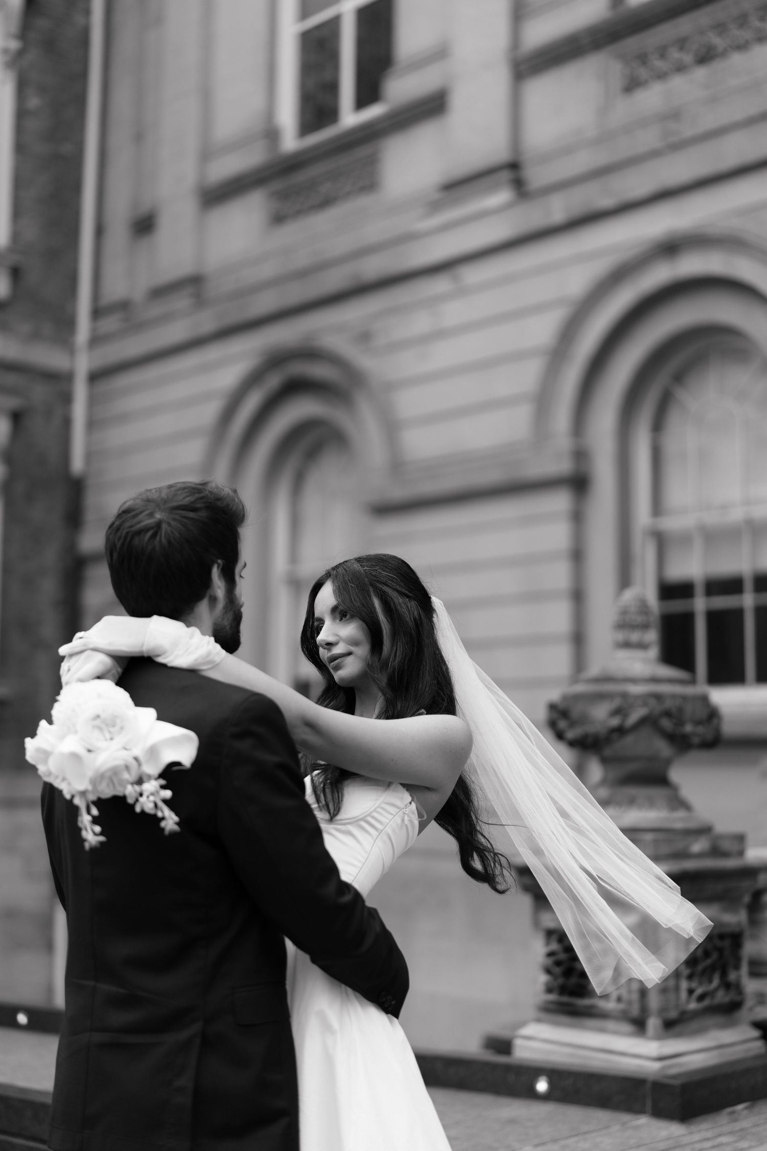 A bride and groom dance together in front of a Toronto  historic building captured by AZ photo studio.