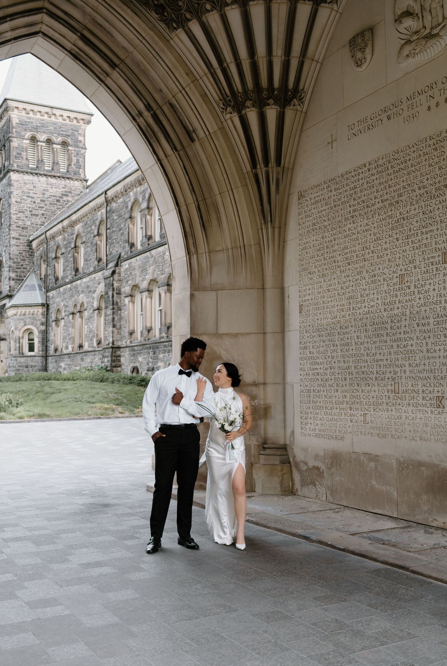 A sequence of wedding photos taken under a stone archway with text inscribed walls at a historic building.