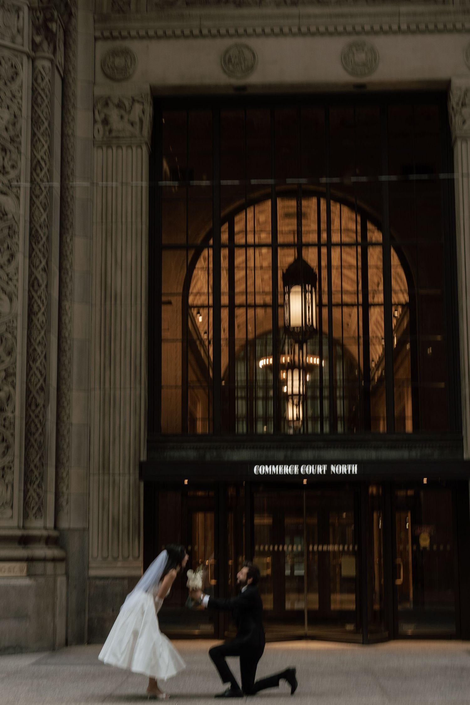 A romantic proposal scene in Commerce Court North in Toronto Captured by AZ Photo Studio.