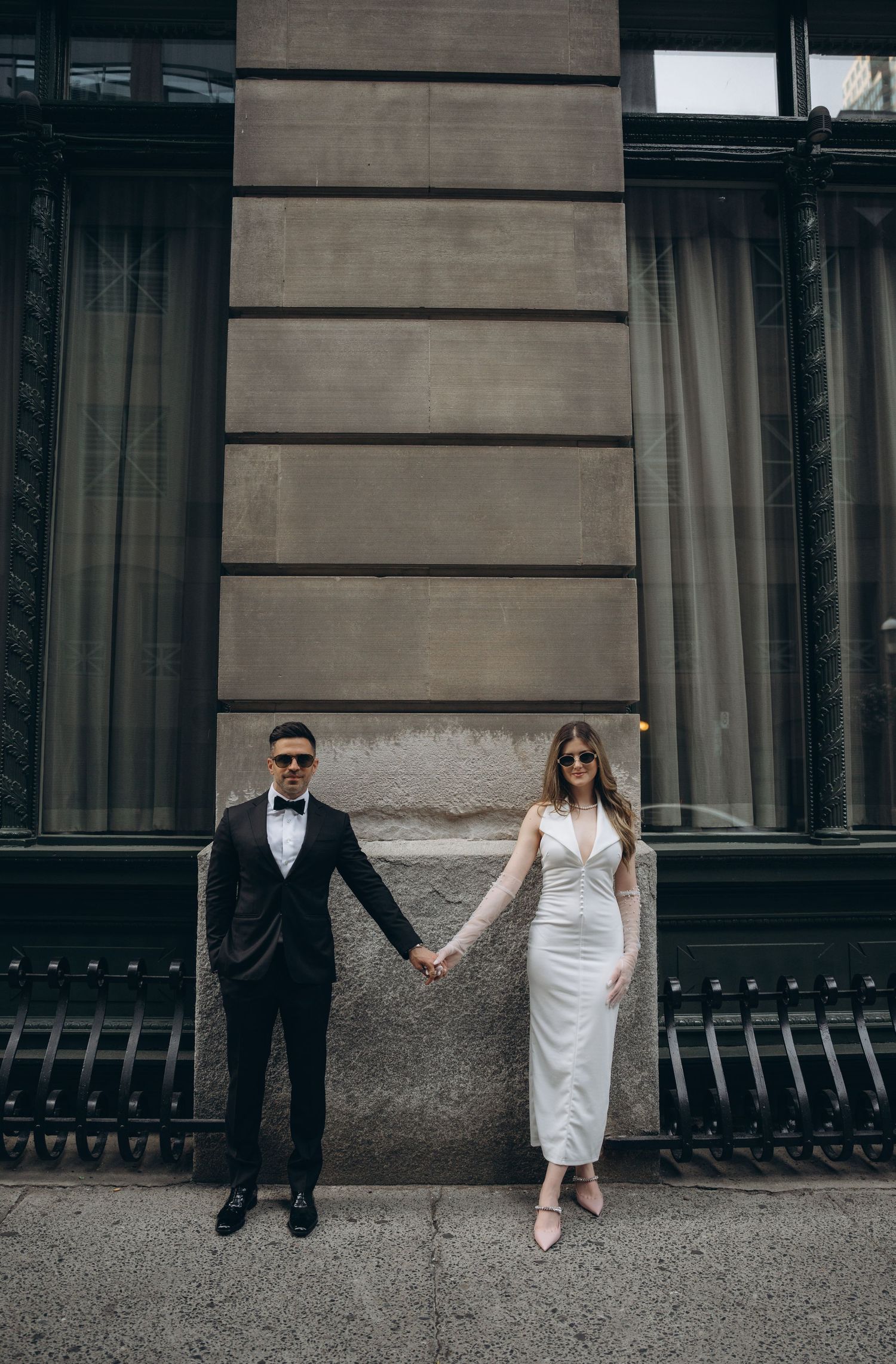 A series of artistic wedding photos showing the couple's legs and feet against a modern building exterior.