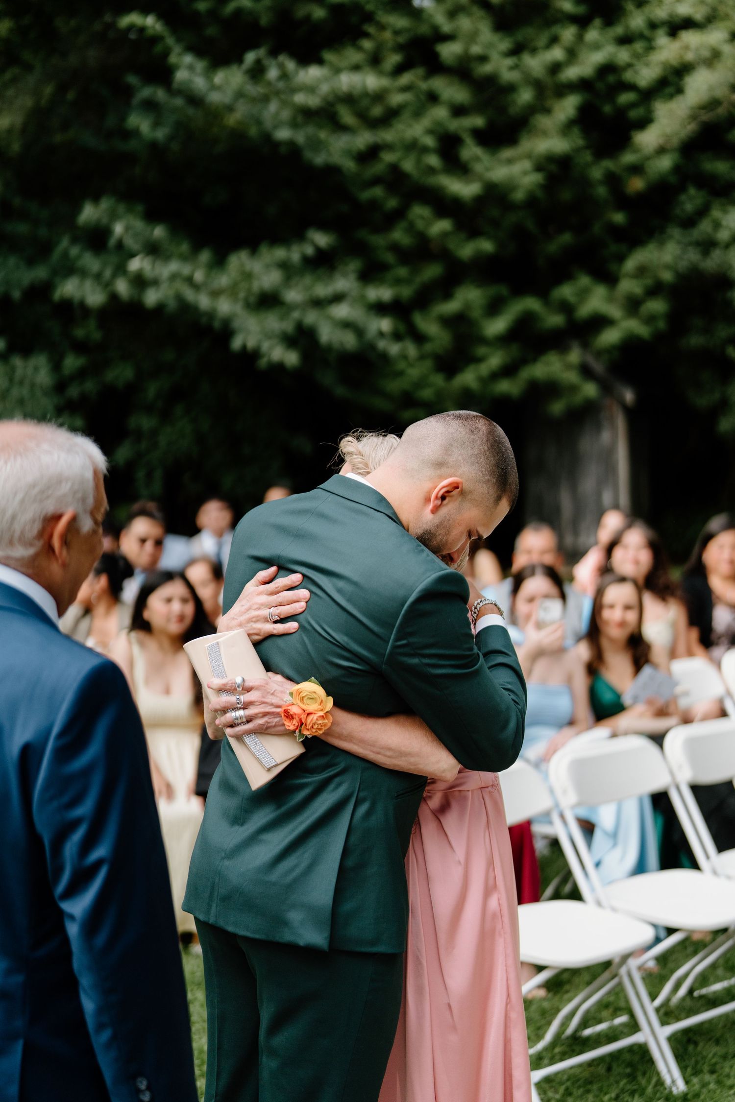 Emotional sequence of wedding ceremony moments showing heartfelt embraces between family members at an outdoor venue.