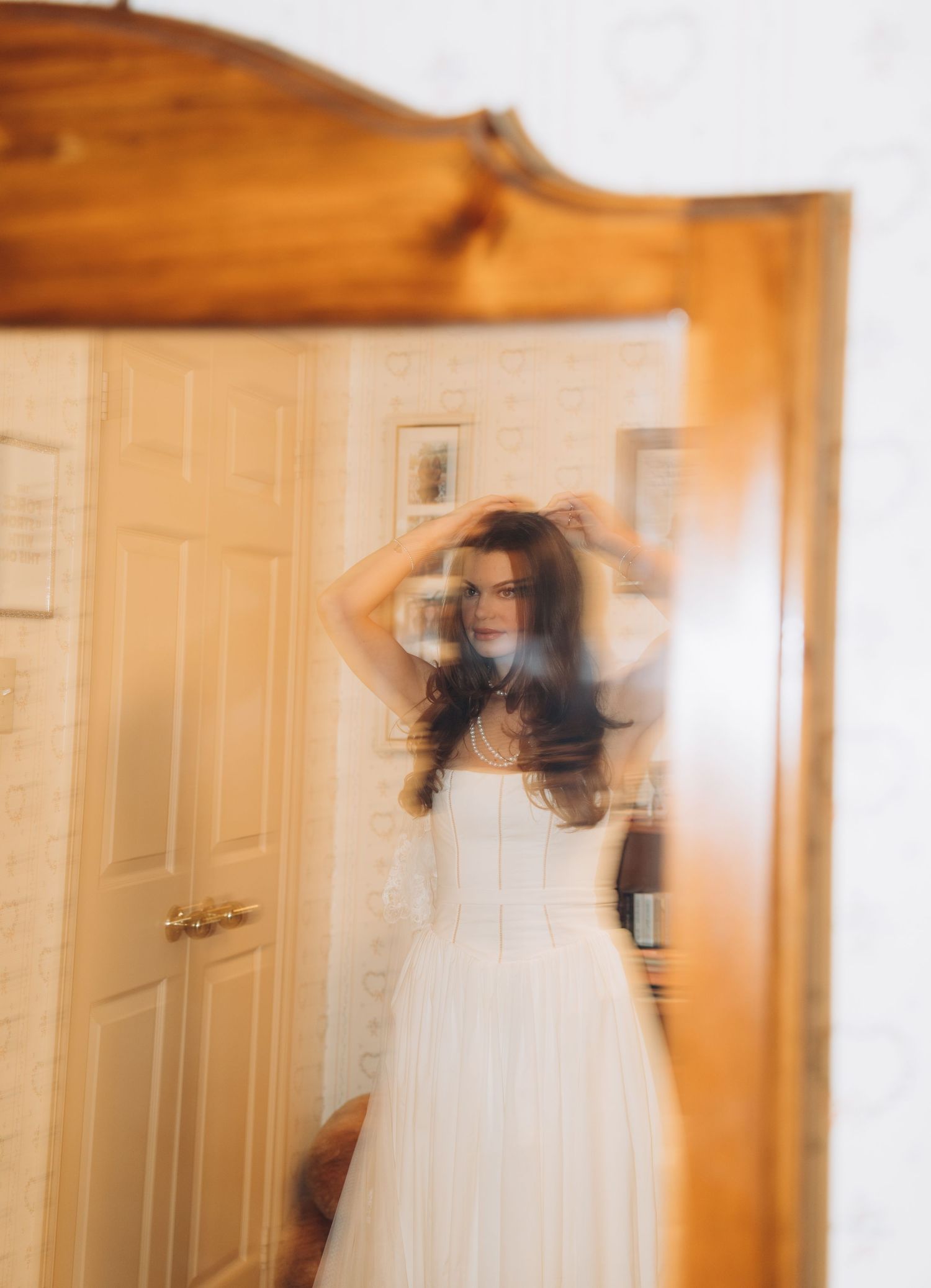 A blurred motion sequence of a bride in white dress through a doorway creates an ethereal trailing effect.