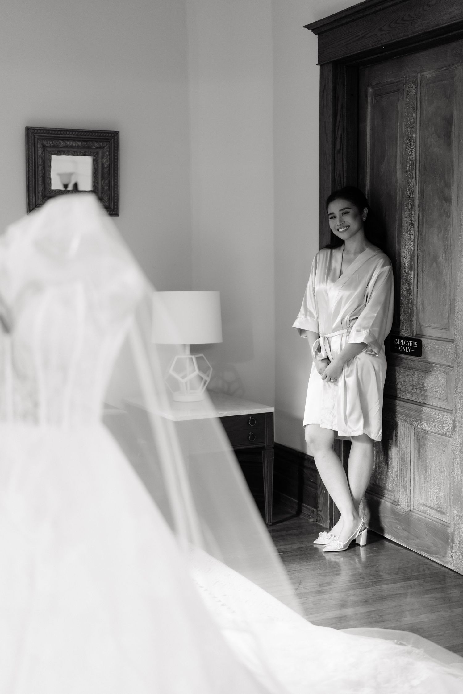 A series of minimalist black and white photographs showing a figure in white against a light wall and doorway.