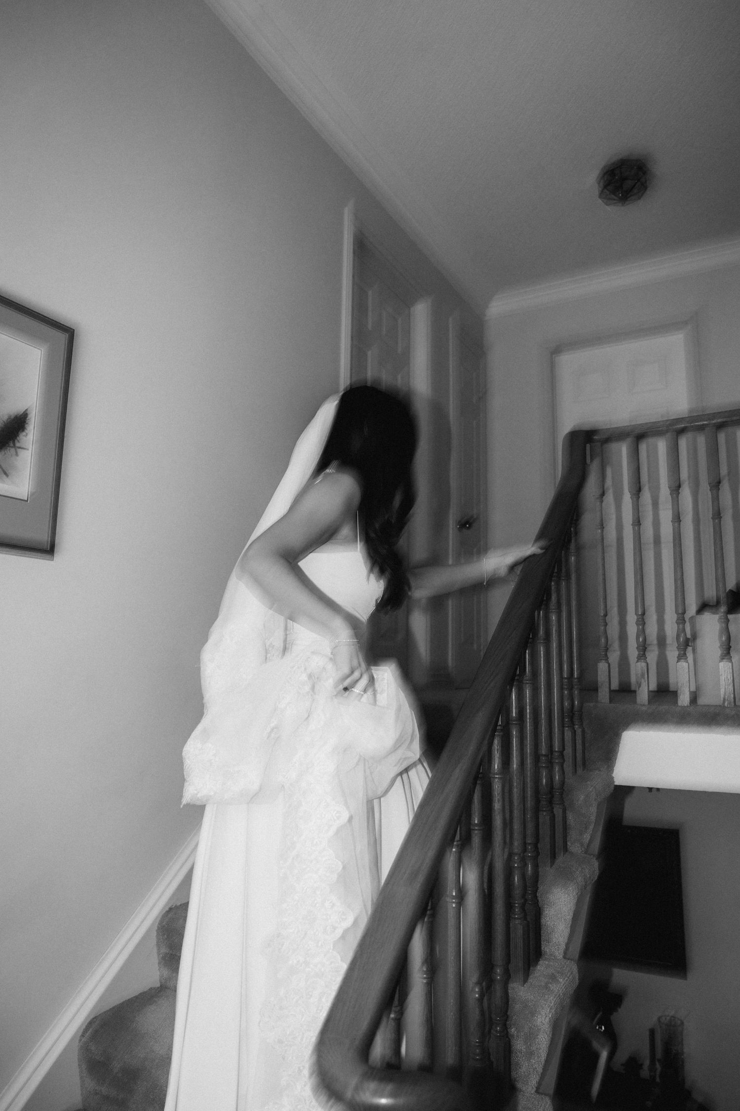A sequence of black and white photos showing someone in a white dress walking down a staircase.