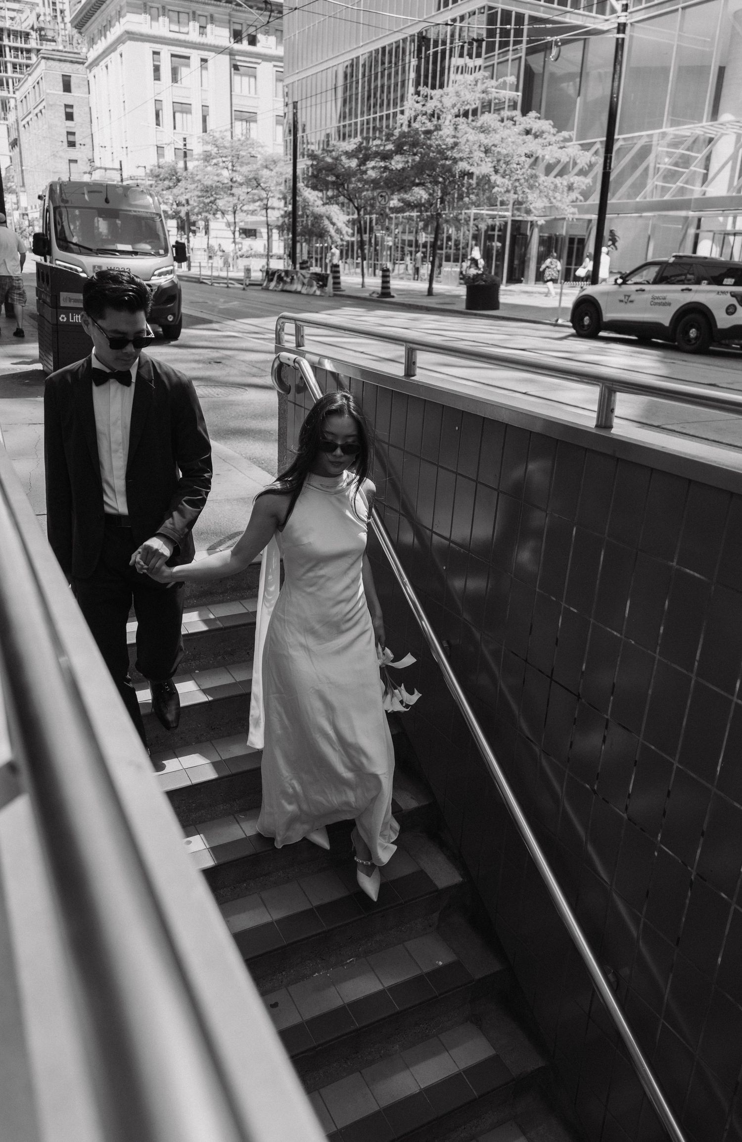 A sequence of black and white photos showing someone carefully descending a stairway with support.