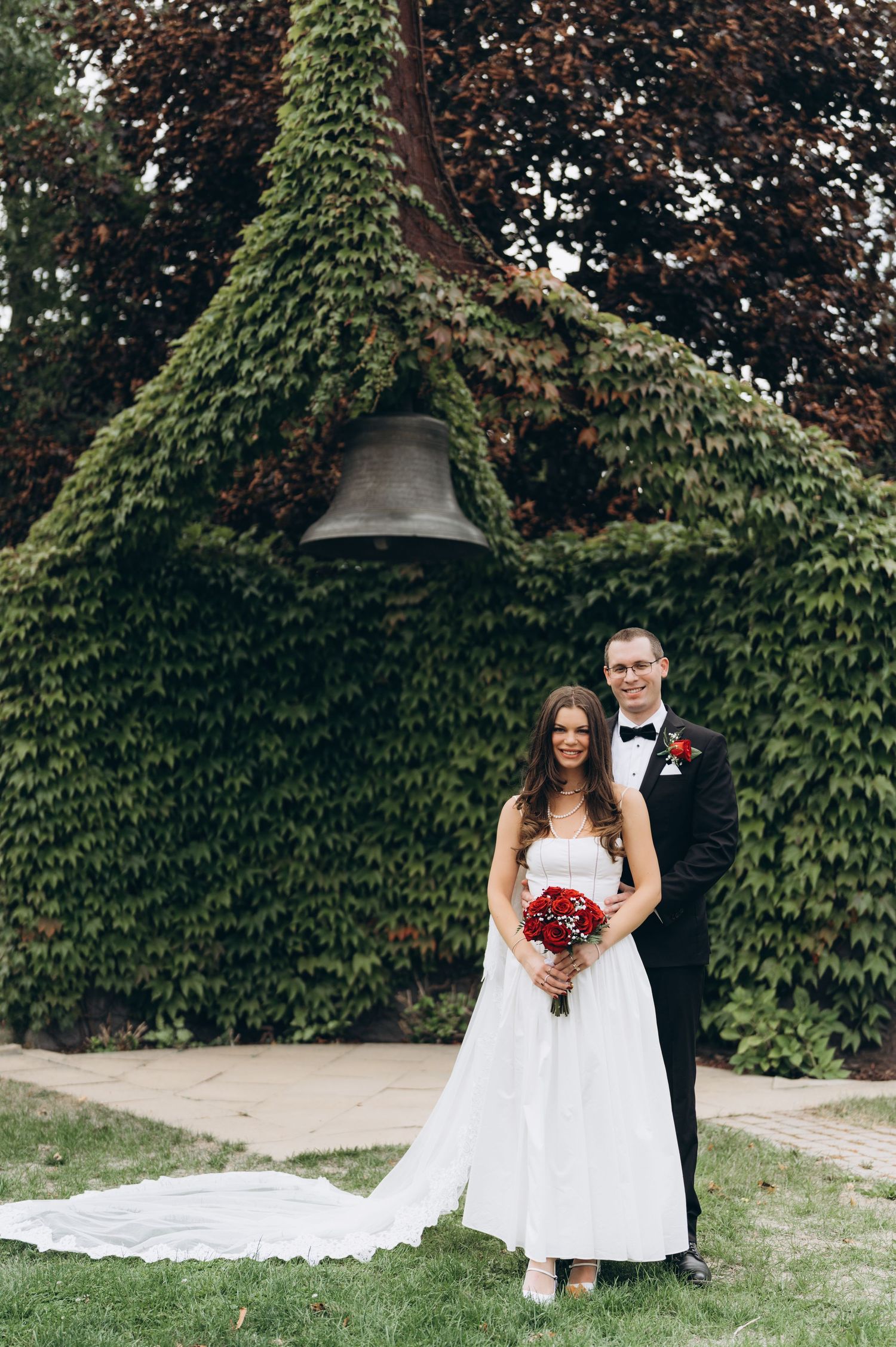 Series of romantic wedding photos against an ivy-covered wall backdrop with deep red floral accents.