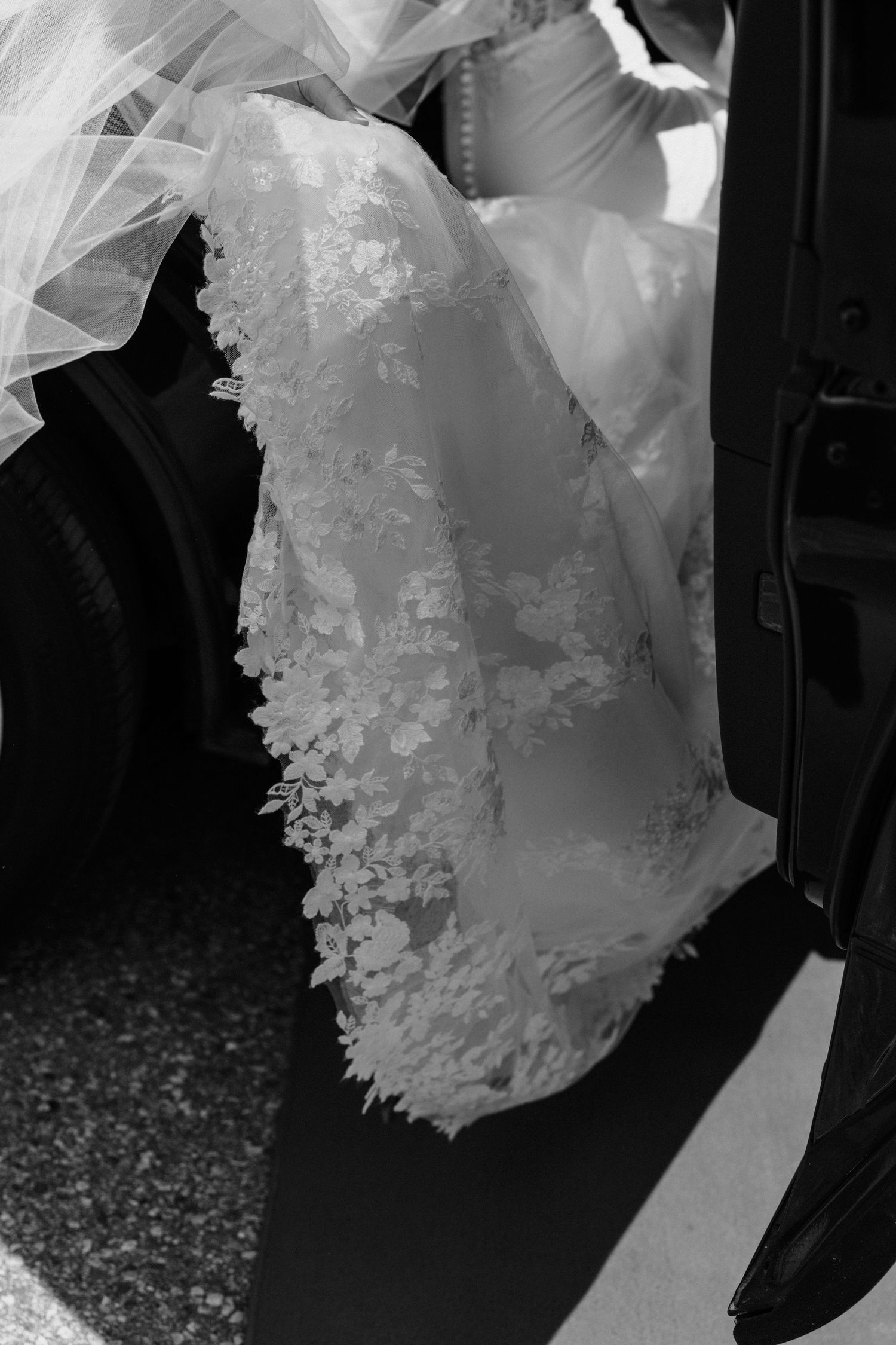 A flowing white wedding dress veil with delicate lace details captured in multiple black and white photographs.