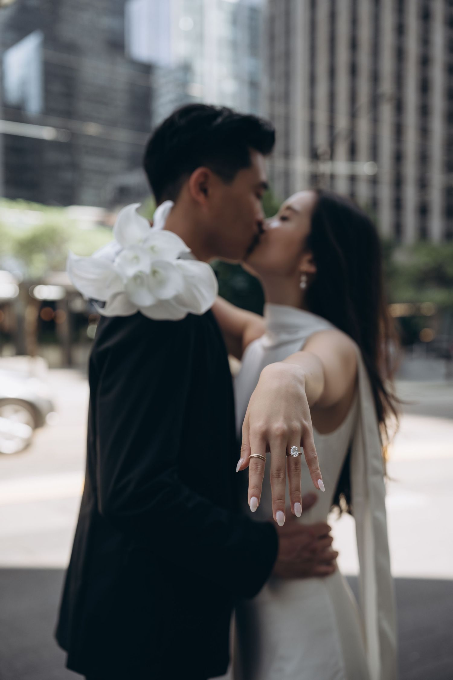 A series of romantic wedding photos showing a couple embracing in an urban setting with blurred backgrounds.