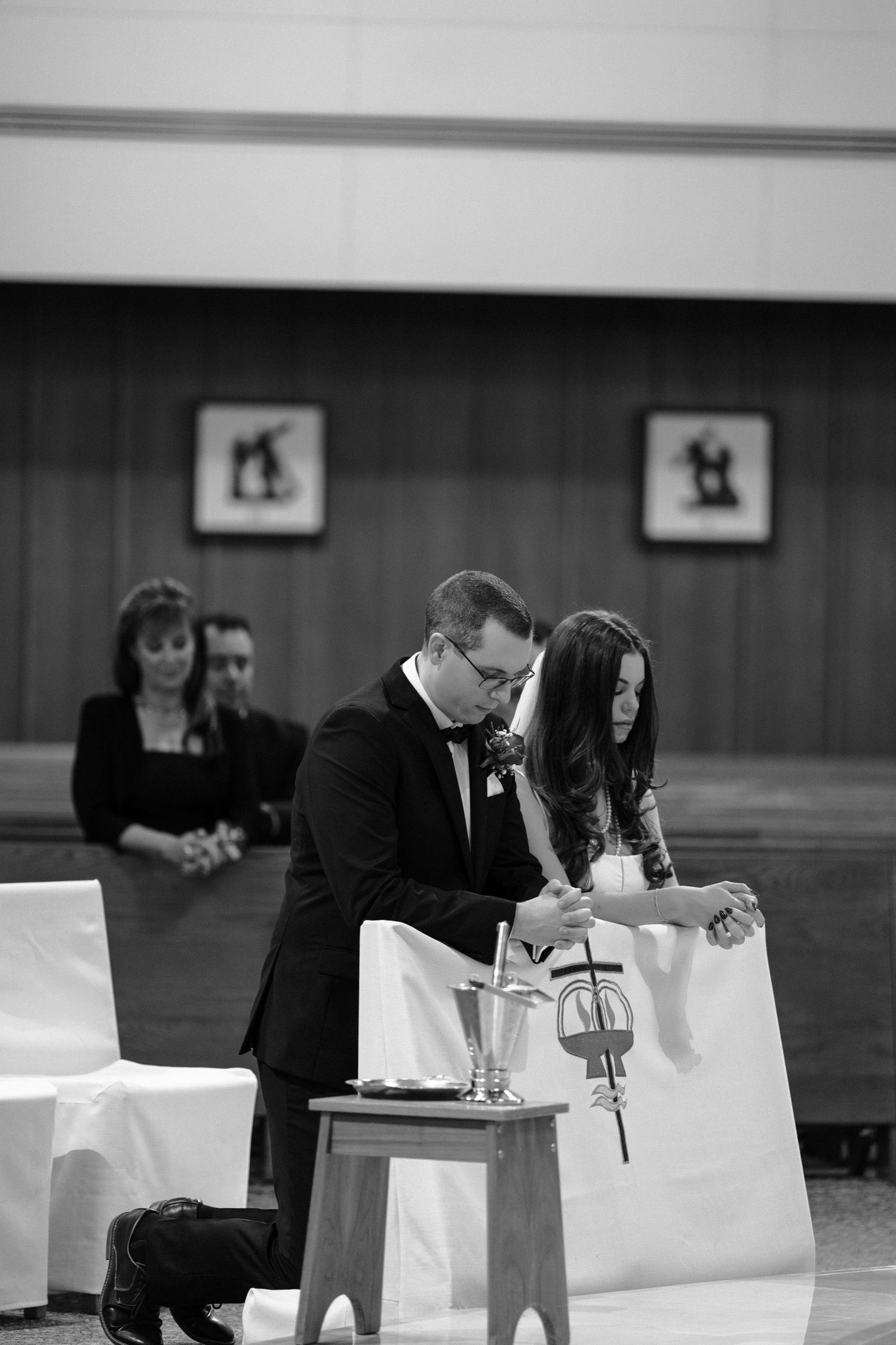 Black and white series of wedding ceremony moments showing document signing at tables.