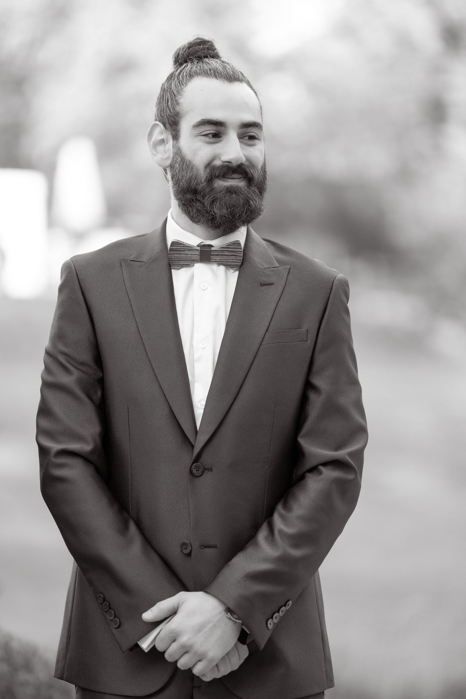 Black and white portrait of formally dressed person with beard and bow tie.