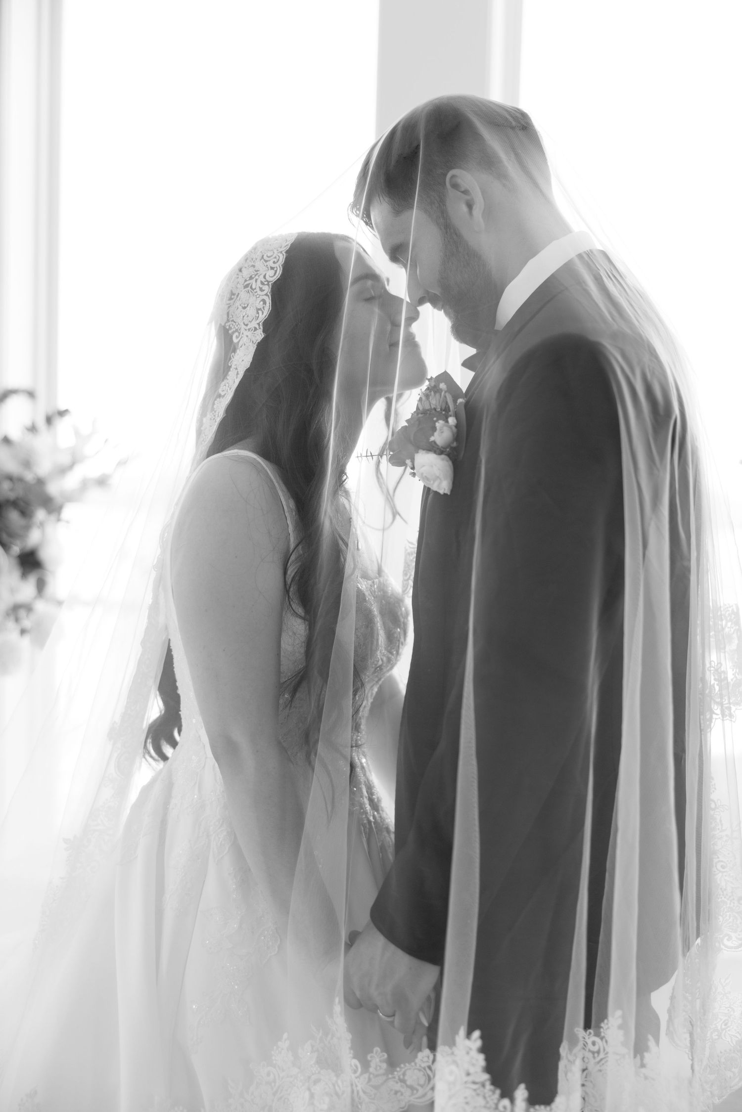 Silhouetted wedding couple in black and white creates an artistic and romantic atmosphere.