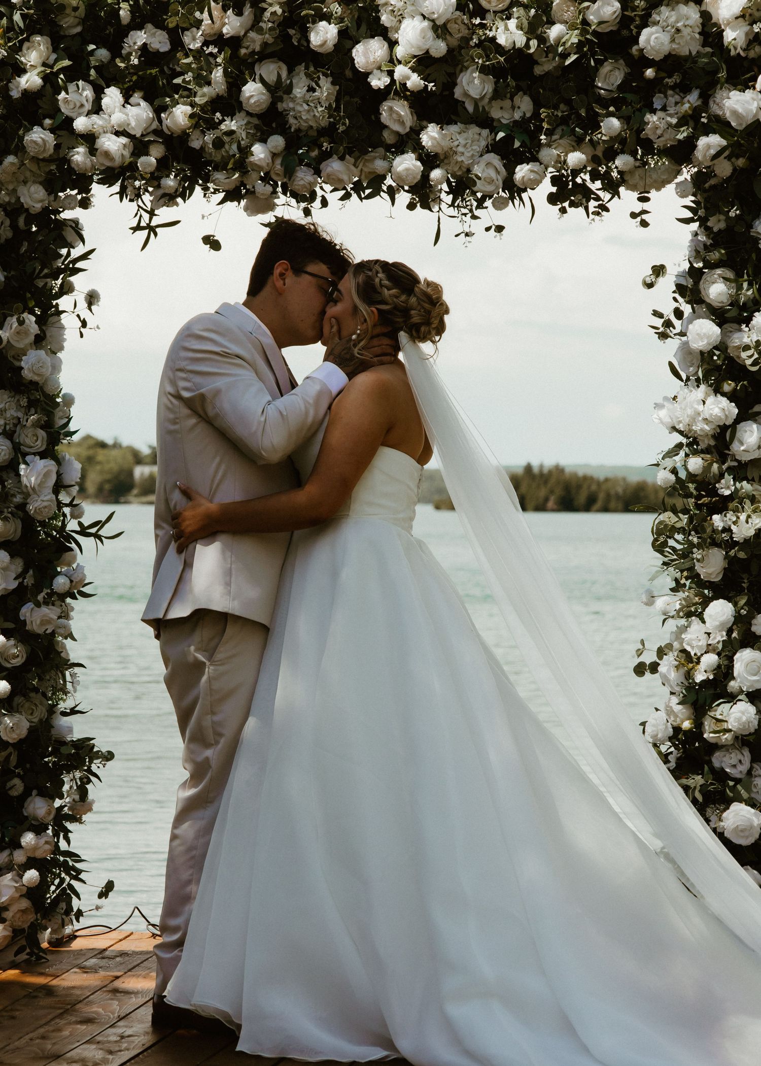 Local Sudbury Wedding Photographer captures bride and groom on wedding day big kiss at altar
