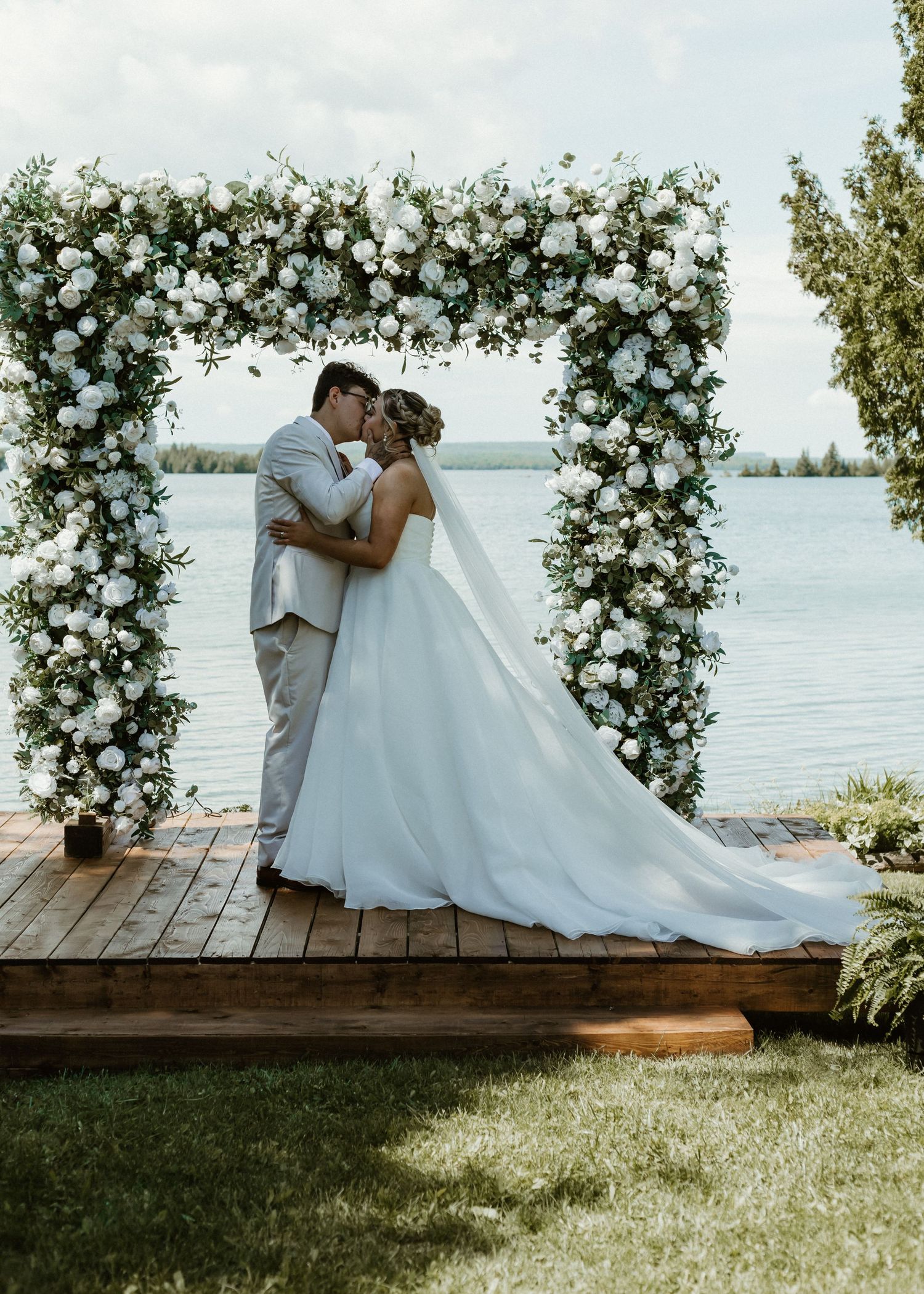 Local Sudbury Wedding Photographer captures bride and groom on wedding day big kiss at altar