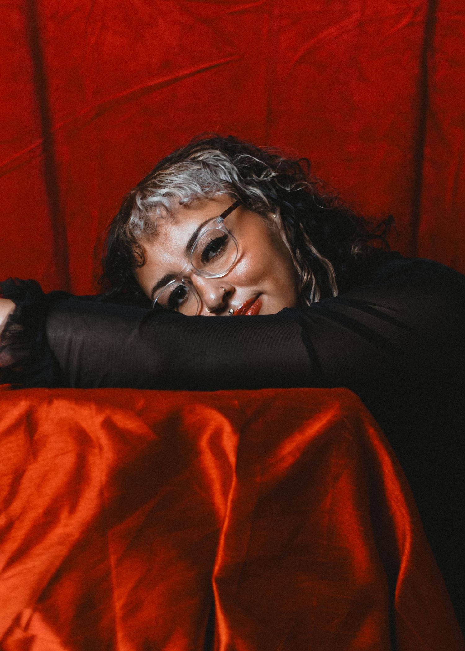 local Sudbury Ontario Boudoir expert photographer provides burlesque boudoir experience to model in black dress